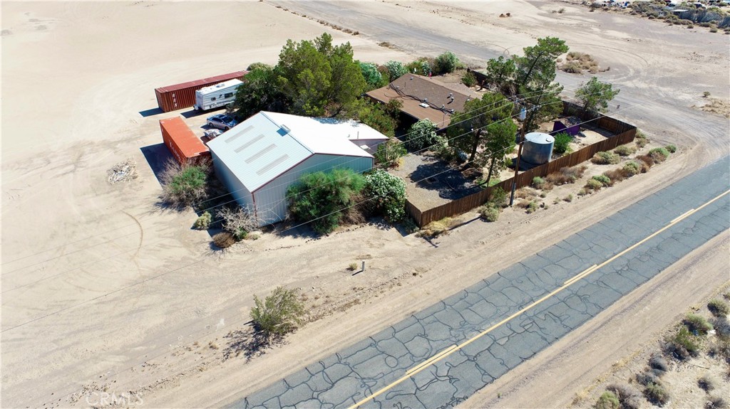 Aviation, History, and Opportunity on 2.83 Acres in Yermo, CA
This is more than just a home, it’s a lifestyle destination. Set on 2.83 acres, this unique and versatile property features a 1,152 sq ft, 3-bedroom, 2-bath home with a split floor plan, vaulted ceilings, and clerestory windows that fill the living space with natural light. The inviting living room flows into a charming kitchen with a dine-up bar and built-in china hutch, making it ideal for gatherings. The primary suite offers a private bath, while two additional bedrooms and a second bath sit on the opposite side of the home. Indoor laundry and a wide, covered veranda with a spa and water feature complete the main home’s offerings.
Just steps away, a breezeway leads to the heart of this property’s uniqueness—a 40'x40' airplane hangar with insulated ceilings, evaporative cooling, and a roll-up door that opens to a historic 2,500 ft private airstrip, grandfathered in since 1955 spanning across multiple parcels behind the property. This airstrip has a story of its own, once famously used by a well-known celebrity (per seller) and designed to accommodate Cessnas, Pipers, and even twin-engine aircraft.
Connected to the hangar is a 384 sq ft fully functional shop with a half bath, electricity, and cooling. Currently operating as a classic car workshop known to host celebrity clients and featured on TV shows. Could Easily be converted to a ADU for next-gen living or income potential. Whether you're an aviation enthusiast, car collector, or entrepreneur, this space is primed for creativity and business.
Outside, you’ll find a fenced yard with mature shade trees, low-maintenance landscaping with drip irrigation, a koi pond, and plenty of room to grow. Major upgrades include a updated HVAC system, new well and pump, and a new septic system, offering peace of mind and move-in readiness.
Located just 10 minutes from Calico Ghost Town, 4 minutes to Eddie’s World, 40 minutes to Victorville, and 2 hours from Las Vegas this is the perfect mix of privacy, history, and opportunity.
Live, work, fly, and create—all from one extraordinary property.