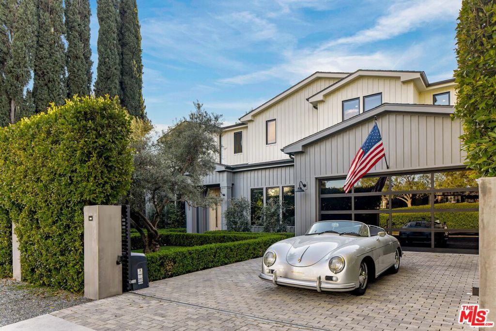Beautifully gated farmhouse-styled residence centrally located within Studio City. This newly constructed home boasts a spacious, favorable layout with an entryway flanked by both a formal living and dining room, flowing seamlessly to the enviable chef's kitchen, fully equipped with high-end dual appliances, a large marble waterfall island, custom cabinetry and a banquet-style breakfast nook. The vast family room opens to a private garden, featuring a large pool and spa, fire pit, outdoor patios and a charming cabana with an arbor and full bathroom. The primary suite offers luxury and functionality, with designer finishes, a vaulted ceiling, dual closets, and a lavish en-suite with custom hardware, blonde wood vanities, a standing tub, and an oversized marble-walled shower. The home also includes five additional ensuite bedrooms, two more bathrooms (totaling eight),and a second-floor laundry room.The lower level offers a den, guest room/staff quarters, gym, home theater and temperature-controlled wine room. Further features include Smart Home technology for safety and security, a central vacuum system and close proximity to the area's most coveted schools & Ventura Boulevard's best shops and restaurants.