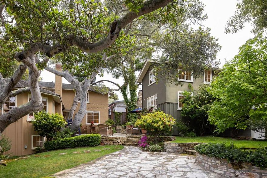 A family compound like no other.  Two very special MJ Murphy cottages on one large lot in a prime location; set behind privacy gates between the ocean and town. Completely redone in 2004 to preserve  their original charm, including single wall construction. Between the windows, the old Carmel stone wood burning fireplaces and the open beamed ceilings, these cottages stir emotion. The grounds are stunning and shared yet easily separated if desired.  Each has lovely Carmel stone patios, grassy yards, gorgeous old oak trees and mature landscape. You can park two cars on property, plus there is a driveway and a two car garage.  Great for co-ownership with a partner or perhaps 30 day vacation rentals. Lots of water credits here. Both homes have sweet back porches and lower level laundry rooms. Both of these cottages are currently used/live as three bedrooms and two bathrooms although county records reflect four beds and two+ baths in each house. This compound has only transferred once in 55 years.