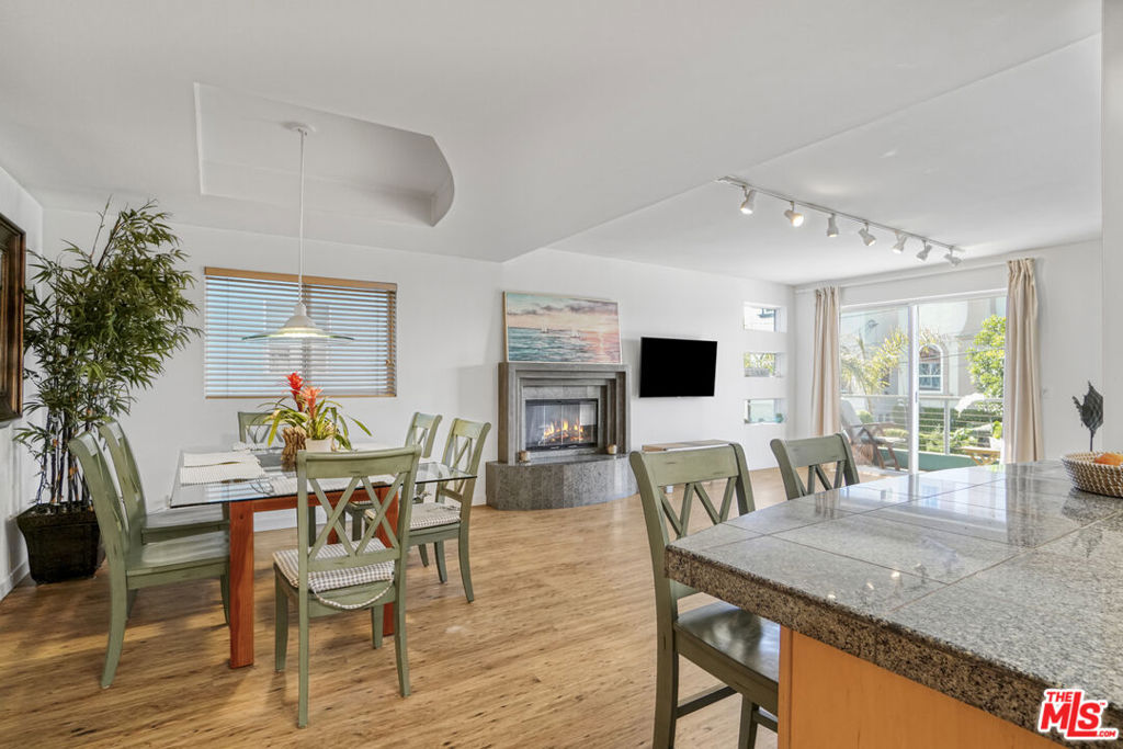 Step into this bright, airy, and beautifully maintained home just moments from the sand in one of Los Angeles' most sought-after beachside neighborhoods. Located in a charming 3-unit building on the Marina Peninsula, this spacious unit offers the perfect blend of tranquility and convenience. Enjoy the ocean breeze from the balcony off the living room, which features lovely walk street views perfect for morning coffee or evening unwinding. The open-concept living area is flooded with natural light and anchored by a cozy fireplace, setting the tone for relaxed, coastal living. The primary bedroom is a true retreat, complete with a spacious private balcony and a large walk-in closet. The second bedroom also offers generous space and its own walk-in closet, providing comfort and functionality for guests, family, or a home office setup. Additional features include an in-unit washer and dryer, two-car covered garage parking, and an EV charger. Thoughtful touches throughout and excellent property management make for easy, low-maintenance living. All of this just moments from the beach, and close enough to Washington Blvd to enjoy top-rated restaurants, shopping, and vibrant nightlife while still enjoying the peace and charm of the Marina Peninsula. Don't miss this rare opportunity to live the California coastal lifestyle at its best. Welcome home.
