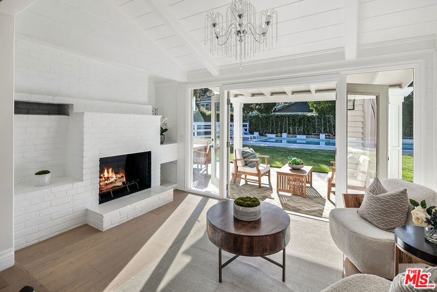 This historically charming East Coast traditional estate is truly the crown jewel of Rancho, perfectly nestled on a picturesque, oak-lined street.Behind the classic white picket fence, you're welcomed by sprawling lawns, manicured hedges, and blooming white roses. Aged Chinese elm trees provide timeless character, while the rare double lot offers an impressive presence. The cobblestone motor court accommodates up to six cars, setting a tone of both elegance and practicality.Inside, the home exudes warmth and sophistication. The formal living room, tucked off the right wing, is bathed in natural light and finished with decorative paneled walls, intricate crown molding, and a romantic custom fireplace. To the left, a spacious step-down family room with an additional fireplace opens to lush green views and your private Olympic-sized pool.The chef's kitchen is a true showpiece. Massive in scale, it blends imported marbles with bespoke cabinetry and abundant storage. Designer appliances make entertaining effortless, while the thoughtful layout flows seamlessly for both cooking and gathering.Upstairs, each of the four spacious bedrooms offers serene natural light and custom-tailored wardrobes designed for modern-day functionality.Situated within distance to parks, grocery stores, tennis courts, Pickwick Ice, Griffith Park, and the Los Angeles Equestrian Center, this estate combines luxury living with unbeatable convenience. Just minutes from major studios including Disney, Warner Bros, and ABC, it's a dream location for both work and play.This one-of-a-kind estate welcomes you to bring your horses, embrace the trails, and ride off into the sunset.