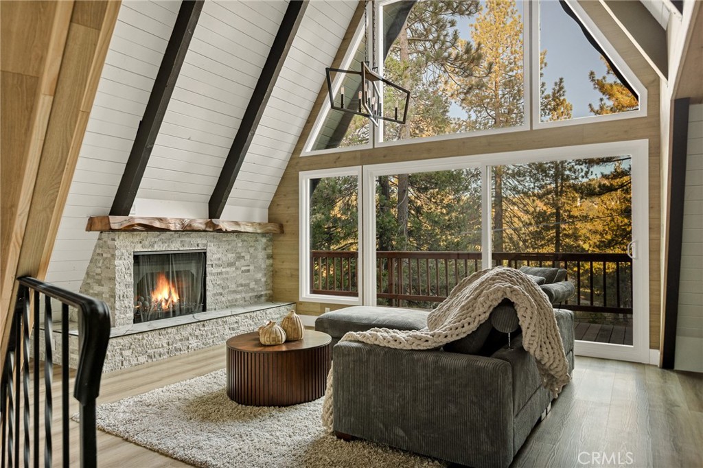Beautifully renovated A frame Lake Arrowhead home with lake rights! This 3-bedroom, 3-bath home offers 1,758 sq. ft. of stylish mountain living on a spacious 14,812 sq. ft. lot near the Lake Arrowhead Country Club and Grass Valley Park. Enjoy a brand-new kitchen with modern stainless steel appliances, an open-concept living area, with wrap around decks and a bedroom and full bath conveniently located on each of the three levels—perfect for guests or multi-generational living. The home also features brand new double pane windows, new central A/C, new mini-split in loft area, a 1½-car garage, ample parking, and serene forest surroundings. Come see this beauty and start enjoying mountain life at its best!