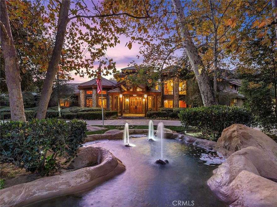 Vacation living all year round. Quiet and private. Set behind private gates & down a long driveway sits this amazing, 6 bed, 6 ½ bath, almost 8,500 square foot estate. Grand architecture with craftsman details. Enormous Great Room/Game Room featuring a wet-bar, built in entertainment center & double-sided stone fireplace with inglenook seating. The remodeled kitchen has granite counter tops, large center island, high-end stainless steel appliances, butler’s pantry & large walk-in pantry. There is also a large wine cellar. The Owner's suite encompasses the entire upstairs & incl. built-in dual desks, stone fireplace, dual closets, large balcony & exquisite bath with dual vanities, jetted tub & steam shower. No luxury has been overlooked. The additional 5 bedrooms are on the main level & in each  you will find a walk-in closet &en-suite bath. Garage parking for 8 cars plus additional RV and motorcycle parking. The approx. 2 ½ acre lot incl. a lighted N/S Tennis Court w/ covered viewing pavilion, fire pit, pitch & putt golf course,Dual BBQ Center & a truly breathtaking fully-tiled pool & spa crowned with a waterfall that cascades from  natural rock formations. Truly a resort, no detail was overlooked, no amenity is lacking, and this estate is exceptional in every way. Coveted 24-hour guard gated neighborhood is convenient to 118-fwy, dining, and  entertainment.