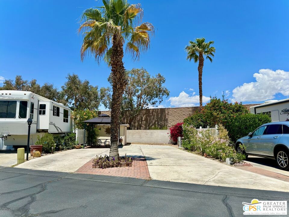 Located on the highly desirable year-round occupancy side of Desert Shadows RV Resort, this premium RV lot offers the rare opportunity to enjoy full-time desert living, something not available throughout the entire resort. With spectacular views of the surrounding mountains, clubhouse, greenbelt, and pond, this lot is truly one of a kind. You won't find a condo or small home in the Palm Springs area at this price point where you own the land, making this an unbeatable value whether you're seeking a seasonal escape, a full-time residence, or a long-term investment. Beautifully landscaped and thoughtfully equipped, the lot features a privacy wall at the back, a large shed for storage, and a spacious gazebo perfect for outdoor dining, lounging, or entertaining. Desert Shadows is a vibrant gated 55+ community with 460 individually owned lots and some of the best amenities in the Coachella Valley. Residents enjoy access to six heated pools, including an Olympic-sized lap pool and an indoor pool, along with spa and sauna facilities. The resort also features sunken, lit tennis and pickleball courts, indoor shuffleboard, a full gym, a woodshop, card and hobby rooms, a putting green, a dance studio, multiple picnic areas, and a grand 16,000 sq. ft. ballroom hosting events and activities year-round. Low monthly HOA dues of just $420 include water, trash, sewer, basic cable, clubhouse Wi-Fi, recycling services, and professional landscaping around your unit, providing convenience and peace of mind. Don't miss this exceptional opportunity to own a prime lot in one of the desert's most well-appointed and welcoming communities. Contact us today to schedule a tour or request more information!