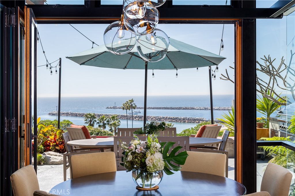 Get ready to experience the ultimate in coastal living with this exquisite Tahitian modern villa—where breathtaking front-row ocean views greet you from nearly every room. Spanning an impressive 4,500 square feet, this home offers an open-concept floor plan designed to blend luxury, comfort, and effortless style. The expansive ocean-facing patio is perfect for relaxing or entertaining, while floor-to-ceiling windows flood the home with natural light and frame the stunning coastal vistas. Featuring four spacious bedrooms and four beautifully appointed bathrooms—two on each level—this villa offers both comfort and privacy. The chef’s kitchen is a culinary dream, outfitted with top-of-the-line appliances and generous counter space, making it ideal for cooking and entertaining. Unwind in the luxurious spa or gather around the firepit as you take in the spectacular ocean views. Upstairs, you’ll find a dedicated ocean-view workout room, a private office or optional fourth bedroom with a balcony, and flexible living space designed to fit your lifestyle. A striking aquarium adds a touch of elegance and tranquility, elevating the ambiance throughout the home. Perfectly blending modern design with coastal charm, this villa is a true sanctuary for those seeking peace, style, and the very best in luxury amenities.