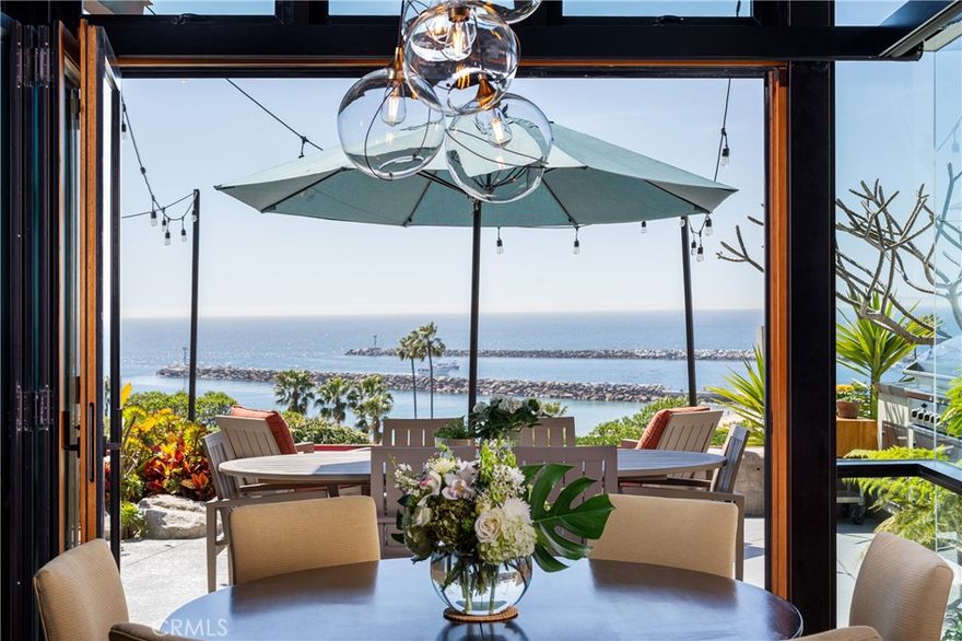 Get ready to experience the ultimate in coastal living with this exquisite Tahitian modern villa—where breathtaking front-row ocean views greet you from nearly every room. Spanning an impressive 4,500 square feet, this home offers an open-concept floor plan designed to blend luxury, comfort, and effortless style. The expansive ocean-facing patio is perfect for relaxing or entertaining, while floor-to-ceiling windows flood the home with natural light and frame the stunning coastal vistas. Featuring four spacious bedrooms and four beautifully appointed bathrooms—two on each level—this villa offers both comfort and privacy. The chef’s kitchen is a culinary dream, outfitted with top-of-the-line appliances and generous counter space, making it ideal for cooking and entertaining. Unwind in the luxurious spa or gather around the firepit as you take in the spectacular ocean views. Upstairs, you’ll find a dedicated ocean-view workout room, a private office or optional fourth bedroom with a balcony, and flexible living space designed to fit your lifestyle. A striking aquarium adds a touch of elegance and tranquility, elevating the ambiance throughout the home. Perfectly blending modern design with coastal charm, this villa is a true sanctuary for those seeking peace, style, and the very best in luxury amenities.