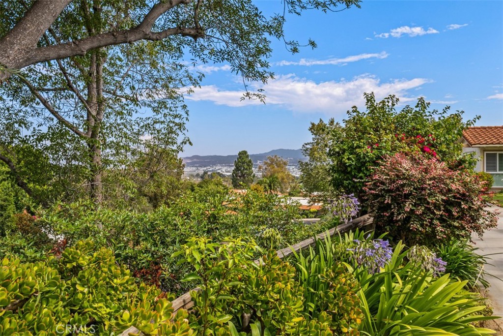 Welcome to this beautifully updated, cottage-style La Casita corner unit—filled with natural light, surrounded by peaceful views, and offering the privacy of no neighbors above, below or across from unit. Perfectly located on a quiet hilltop near Gate 8, this one-bedroom home overlooks rolling hills, mature trees, and twinkling city lights in the evening. Enjoy your morning coffee or evening glass of wine on the brand-new tiled patio, where gentle breezes create the perfect spot to relax. Inside, the remodeled kitchen offers Quartz countertops, fresh cabinetry, stainless sink, and new appliances—including a range, refrigerator, vent hood, and convenient washer/dryer combo. Every detail has been refreshed for comfort: upgraded vinyl plank flooring and baseboards throughout, new vinyl-clad windows, and new central air and heat system for year-round enjoyment. The bathroom features a new Quartz-topped vanity, upgraded cabinetry, and a refinished tub/shower with modern fixtures. Convenient covered parking in Carport 3036 space 06. Located in the sought-after Laguna Woods Village, one of the nation’s most desirable 55+ communities, you’ll have access to exceptional amenities: 7 clubhouses, 5 swimming pools and hot tubs, 3 fitness centers, a 27-hole golf course plus Par 3 course, tennis, pickleball, horseback riding, garden center, card rooms, over 250 social clubs, free shuttles, and much more—all in a safe, welcoming, gated environment. This inviting home offers the perfect blend of comfort, convenience, and community—ready for you to enjoy the next chapter of life.