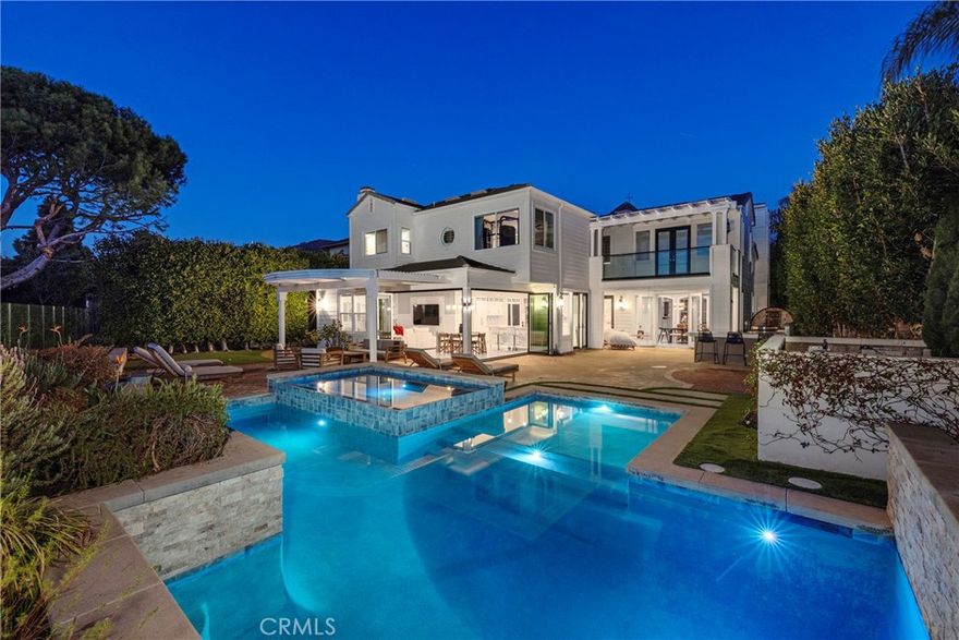 Sunset Views & Ultimate Privacy await you at this Peninsula estate. On-trend luxury meets timeless craftsmanship in this completely reimagined, no-expense-spared remodel—an exceptional, turnkey residence overlooking the golf course. Inside, the home has been transformed with Carerra marble flooring, smooth-finish walls, custom wainscoting, and designer-selected finishes throughout. The true showpiece is the epicurean chef’s kitchen, featuring Calcutta marble surfaces, custom cabinetry with soft-close hardware, a Miele dishwasher and refrigerator, an oversized La Cornue range, and Gaggenau built-ins, including a professional espresso/gourmet coffee system and steam oven. With over 4,000 sq. ft. of refined interior living space, the home offers four bedrooms, including a main-floor bedroom and full bath, plus an office area, and bonus room that can easily be converted to a fifth bedroom. Every room showcases thoughtful craftsmanship, from custom moldings and beams to coffered ceilings, hand-crafted fixtures, and a combination of Carrera marble and rich wood flooring. Bifolding doors open to a lush backyard complete with pool, spa, outdoor kitchen and unobstructed golf course views. Located within an award-winning school district and set inside a 24-hour guard-gated community, this residence offers luxury, security, and convenience at the highest level. Completely updated, meticulously finished, and truly move-in ready—this is coastal-golf-course living at its finest.