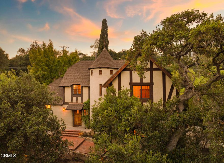 Romance Is In The Air! Gracefully situated along Ojai's prestigious Foothill Road, this fairytale treasure embodies a rare fusion of historic grandeur and refined modern living, the result of a meticulous restoration that honors its original 1929 Tudor Revival design. Designated a Historic Landmark, this 1929 architectural jewel was commissioned by silent screen star Estelle Clarke and designed by esteemed architect Austin Pierpont. During the 1930s, Clarke and her husband, legendary composer Leo Robin, called the estate home. It was here that Robin penned timeless classics, including Bob Hope's signature song, Thanks for the Memory. Fully restored with an emphasis on preserving the integrity of its original Tudor Revival design, the estate harmoniously blends vintage elegance with modern comfort. The 1.17-acre grounds with epic views encompass a 4-bedroom, 3.5-bath main residence, an enchanting barn and a detached yoga studio, offering versatility and privacy. Inside the main residence, architectural details abound: an oversized living room with soaring barrel ceilings, Venetian plaster walls, exquisite original oak and mahogany parquet flooring, and stunning leaded and stained-glass windows that bathe the interiors in natural light.The outdoor setting is equally enchanting. Lush gardens, a serene pool and spa, a pergola-shaded glass pool house, an interior courtyard, and an expansive terrace provide an idyllic backdrop for entertaining set against the breathtaking panorama of Chief Peak and the Topa Topa Mountains. Ideally located in the heart of the Ojai Valley, this iconic estate offers effortless access to scenic hiking trails, renowned farmers' markets, downtown Ojai's dining, boutiques, wine tasting rooms, and the world-class Ojai Valley Inn. A rare opportunity to own a cherished piece of Ojai's architectural and cultural history!*The property is part of the Mills Act which results in reduced property taxes.*,