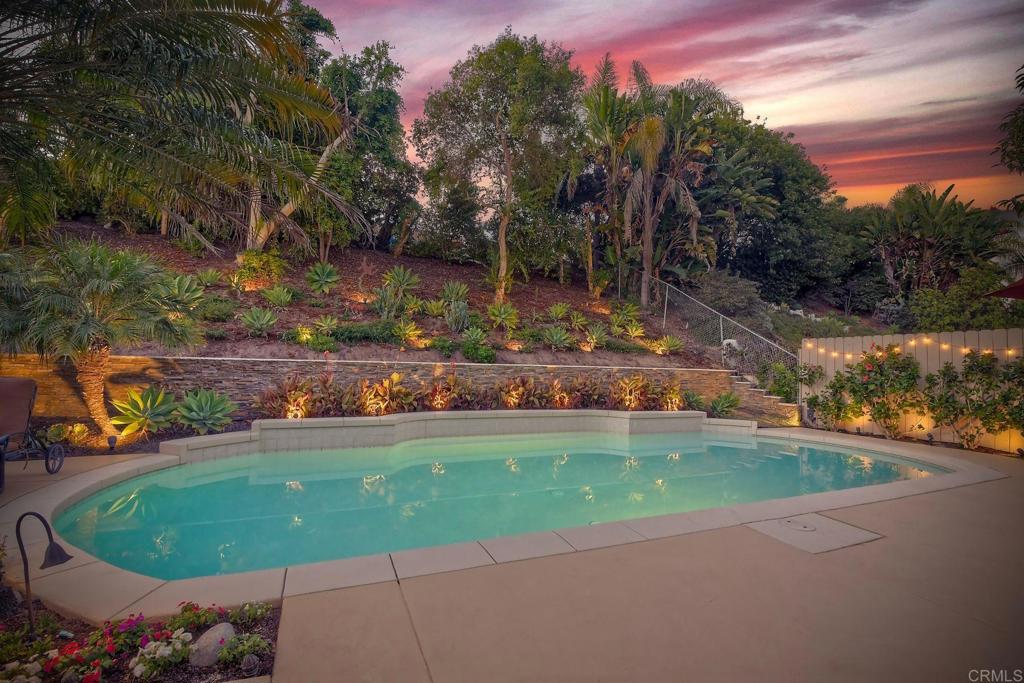 Resort-Style Living in a Quiet, Family-Friendly Neighborhood. Step into luxury with this beautifully upgraded home designed for comfort, functionality, and entertaining. The open-concept kitchen and family room are the heart of the home, featuring a large island, Omega cherry hand-rubbed solid wood cabinetry, Brazilian granite counter tops, and a tumbled Travertine back splash. High-end appliances include a Sub-Zero counter-depth refrigerator, Bosch 5-burner gas cook top, over sized dishwasher, warming drawer, and LG convection oven with microwave. The spacious primary suite offers a relaxing retreat with custom closets and ceiling fan. A gorgeous re-imagined primary bath features a large glass-enclosed shower, separate Jacuzzi soaking tub, and Italian tile finishes with dual sinks. Step outside to your backyard paradise, complete with a lighted solar-heated pool, newly resurfaced patio, lush landscaping, artificial turf, and a charming flagstone garden patio. Multiple dining and lounging areas—including a “secret garden” ideal for alfresco dining or morning coffee—make this the perfect setting for entertaining. Enjoy outdoor living with built-in speakers, extensive auto-controlled lighting, and plenty of space to gather. The garage has been fully upgraded with a newly epoxied floor, custom cabinetry with ample storage, and a large rolling workbench. Additional features include: Owned solar system (27 panels, 9-kilowatt.) with net metering—no electric bill. Central air conditioning. Arlo security system. Low HOA fees. A family-friendly community with three nearby parks. Highly ranked school district and convenient shopping close by. This exceptional property blends everyday comfort with thoughtful luxury, offering the perfect setting to create lasting memories.
