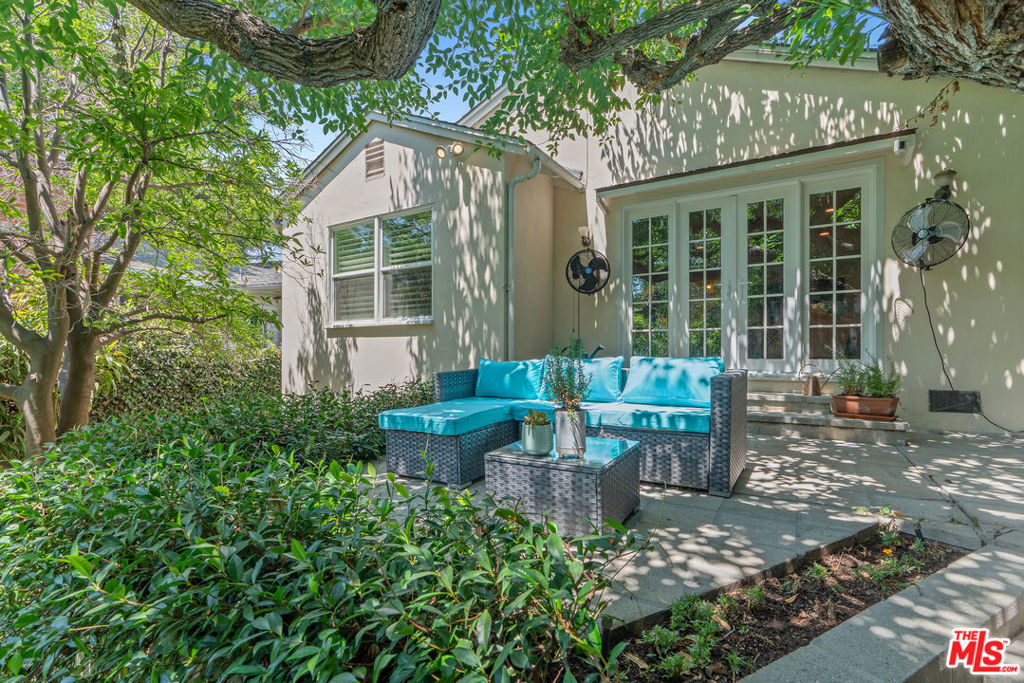 Charming Hollywood Dell Traditional with Lush Yard & Prime Location. Nestled on one of the most desirable streets in the Hollywood Dell, this enchanting Traditional-style home blends timeless appeal with modern updates in a truly serene setting. A fenced front yard welcomes you into a warm and inviting interior, featuring a spacious living room with gas fireplace and French doors that open to a private backyard oasis perfect for indoor-outdoor living. The formal dining room connects seamlessly to a beautifully remodeled chef's kitchen and a separate laundry room. The home features two well-placed bedrooms: a guest bedroom near the updated hall bath, and a tranquil primary suite with en-suite remodeled bath and views of the lush, green yard. Outside, enjoy multiple entertainment areas, including a BBQ space off the dining room, a flat grassy yard (low-maintenance synthetic turf) ideal for play or gardening, and hardscaped patios perfect for al fresco dining or lounging. Additional features include Attached 2-car garage w/ electric charger, Central heating & air conditioning. Peaceful hillside location in a highly sought-after neighborhood; just minutes from the best of Hollywood, Los Feliz, Beachwood Canyon, major studios, freeways, and top-rated dining, nightlife, and hiking. This is a rare opportunity to own a turnkey home in one of L.A.'s most charming hidden enclaves. A true gem not to be missed!