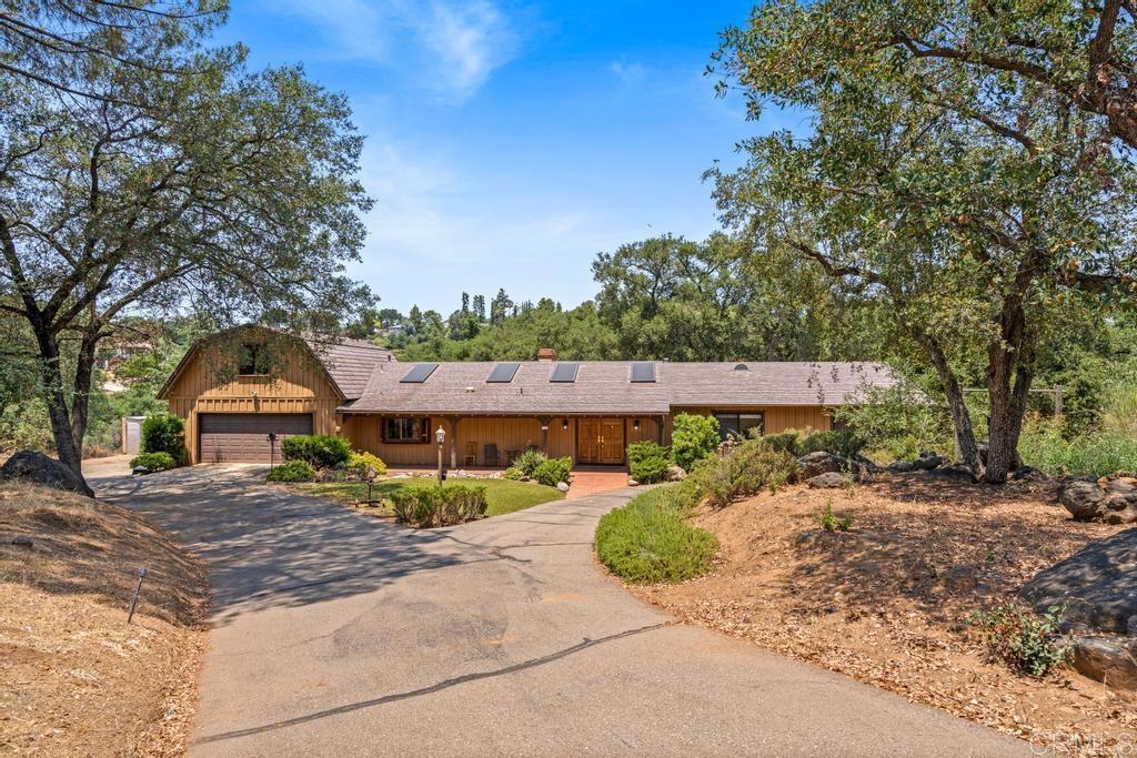 Country charm. If access to a private lake and recreation wasn’t enough, this home has amenities and features that will check your boxes. Sprawling layout with vaulted ceilings, exposed beams and oversized skylights allows for natural light to flood through the home. The expansive primary is complete with a walk-in closet that you could almost consider another room and an ensuite bathroom. The only second story portion of this home is a bonus room over the garage that could serve a number of uses catered to your lifestyle. The kitchen area incorporates a brick island and substantial hood over the stove, ahead of its time. Plenty of space and parking with a long circular drive and not one, but two 2 car garages. Mature oak and native trees scattered throughout the property providing plenty of shade and scenery. Come explore this special property today!