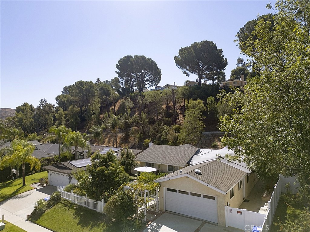 Exceptional Home in a Tranquil, Convenient Location. Set on a tree-lined, established street just two minutes from the freeway exit, this residence offers both convenience and a peaceful, nature-like setting. The spacious lot features a front yard with fruit trees and a large backyard with storage, gardening space, and mature greenery. Inside, a functional floor plan provides direct access to the backyard from the dining and kitchen areas. A fourth bedroom and laundry area have been added, while the garage has been professionally converted into a one-bedroom dwelling (non-permitted).Additional highlights include leased solar panels providing monthly savings and an electric car charger already in place. Move-in ready and well-maintained, this property is an excellent opportunity.