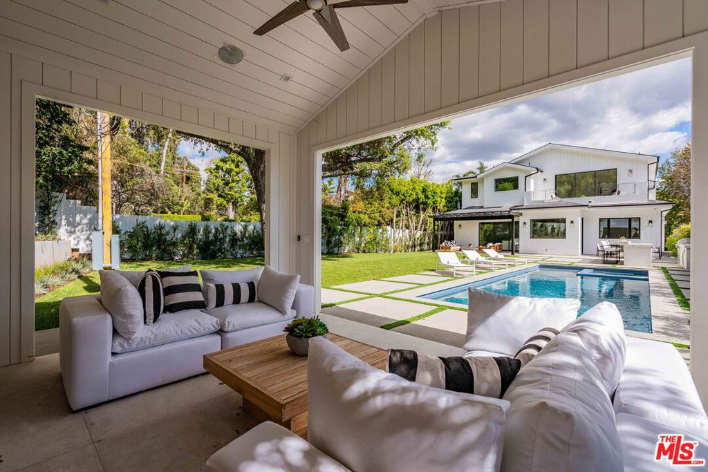 This exceptional, newly constructed Modern Farmhouse in prime Brentwood boasts an open floor plan, warm woods and custom finishes of luxurious living space featuring 5 bedrooms, 6 bathrooms, a dedicated office, state of the art movie theater, and outdoor cabana. Completed in 2022, and with no expense spared, this luminous home features soaring ceilings, wide-plank hardwood floors, Fleetwood sliding glass pocket doors, and designer finishes & fixtures. The gourmet chef's kitchen features designer millwork, book-match slab countertops, walk-in pantry and butler's pantry, an enormous island with dual sinks, & Wolf & Sub Zero appliances. The Primary suite features a spacious balcony, inviting fireplace, spacious walk-in closet, spa-like bathroom with soaking tub, & a massive rainfall steam shower w/ dual heads. Set behind gates on one of the largest flat lots in the neighborhood, the serene backyard is an entertainer's paradise featuring a large grassy lawn, oversized pool & hot tub, outdoor kitchen, and a covered cabana with fireplace, perfect for Southern California indoor-outdoor living. This meticulously built residence features every luxury amenity imaginable just minutes away from the best shops, restaurants, and entertainment that Brentwood has to offer.