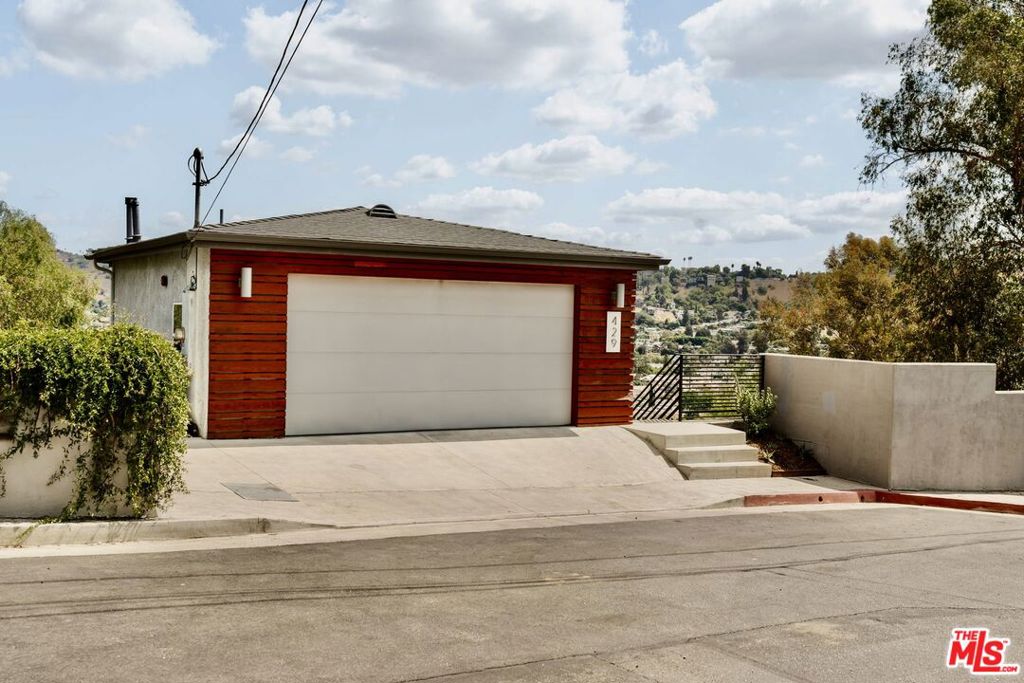 Perched in the hills of Mt. Washington, this modern residence offers a serene retreat with sweeping hillside views and effortless access to Downtown LA, Highland Park, and Pasadena. The light-filled upper level is designed for gathering, with an open floor plan that seamlessly connects the kitchen, dining, and living areas. Sliding doors open to a balcony, perfect for enjoying morning coffee or evening sunsets. The family room is a perfect bonus space for a TV room, office or playroom. Downstairs, you'll find all three bedrooms, including a spacious primary suite with a walk-in closet, an updated bath with a tub and shower. Outdoor spaces are thoughtfully landscaped and terraced, offering multiple areas to dine, relax, and entertain. The front patio is ideal for al fresco meals, and the two backyard terraces provide room for gardening, lounging, or simply taking in the hillside scenery. A dedicated laundry area adds convenience, while the attached two-car garage complete with a Tesla charger supports modern living. From this quiet setting, you're moments away from Highland Park's vibrant dining and nightlife, hiking trails in Debs Park, and neighborhood favorites like Loquat Coffee and Taqueria Frontera in nearby Cypress Park.