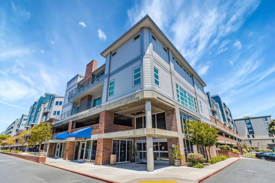 Welcome to your move-in ready home in the heart of Emeryvilles highly desirable Bridgewater Community. This beautifully updated 2-bedroom, 2-bath top-floor corner unit features brand-new laminate flooring and a peekaboo view of the San Francisco skyline from the private balcony. Bright and quiet, the home offers an inviting dining area and a rare wood-burning fireplace, a special feature exclusive to corner units. Two designated parking spaces are included for your convenience.  The Bridgewater Community offers resort-style amenities including a front desk concierge, swimming pool, Jacuzzi, fully equipped fitness center with dance and yoga studio, sauna and massage room, office and study lounge, and a clubhouse. EV charging stations and guest parking are also available. Ideally located just 15 minutes from San Francisco and 10 minutes from UC Berkeley, and close to shopping, dining, and easy freeway access, this home combines comfort, convenience, and community living. Free Emery-Go-Round shuttle to BART. Pet friendly neighborhood. VA & Fannie Mae approved !