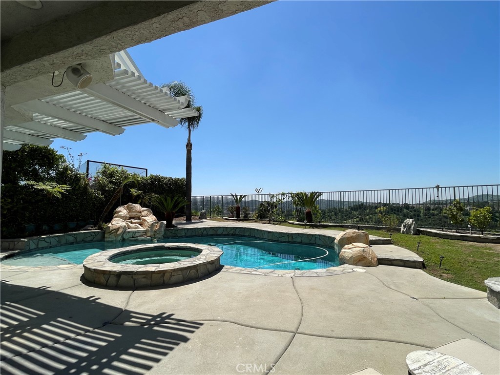 Stunning View Home in Prestigious Diamond Bar with Solar, Pool & Dual Master Suites!
Experience breathtaking panoramic views from this custom 4-bedroom, 4-bathroom estate perched atop a serene cul-de-sac in the hills of Diamond Bar. Located near Ronald Reagan Park and within the award-winning Walnut Valley School District, this beautifully upgraded two-story home offers nearly 2,900 square feet of refined living space.
Step through elegant double doors into a grand entry showcasing a custom wrought-iron staircase, warm mahogany and laminate flooring, and soaring ceilings. The remodeled kitchen is a chef’s dream, featuring granite countertops, a large center island, and a built-in refrigerator/freezer. Adjacent is the expansive family room with a cozy fireplace and custom media niche—perfect for entertaining.
All four spacious bedrooms are upstairs, including two luxurious master suites, each with spa-like bathrooms. Enjoy seamless indoor-outdoor living in the entertainer’s backyard featuring a saltwater pool and spa with waterfall, built-in BBQ, fireplace and fire pit, covered patio with retractable awnings, and built-in surround sound system—all set against a dramatic backdrop of city lights and snow-capped mountains.
Additional highlights include:
Fully paid-off solar system
Attached 2-car garage
Central air & heat
Quick access to 57 & 60 freeways