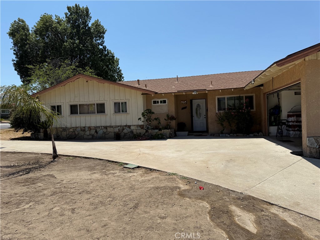 Discover this light-filled, remodeled, 3-bedroom, 2.5-bathroom Corona house. It features a layout that blends kitchen, dining, and living areas. The kitchen is freshly painted and features granite countertops, recessed lighting, and wood cabinetry, leading to a large dining area that comfortably accommodates large groups, ideal for entertaining. The family/living area showcases a modern fireplace that enhances the beauty and comfort of this cozy home. In the hallway, there is a completely remodeled bathroom with a new cabinet with quartz countertop, fixtures and pipping, lighting, floor, and ceramic tile shower area and walls. The main bedroom has its own private bathroom with recessed lighting and a newer cabinet with a granite countertop. The two additional bedrooms and the half bathroom add comfort and convenience. The attached two-car garage has been upgraded with new insulation, walls and new paint and has direct access to the house. This property is equipped with a paid-off solar panel system, dual-pane windows, and air conditioning for year-round comfort. A new vinyl fence surrounding the property has been installed and an array of fruit trees creates a welcoming space.