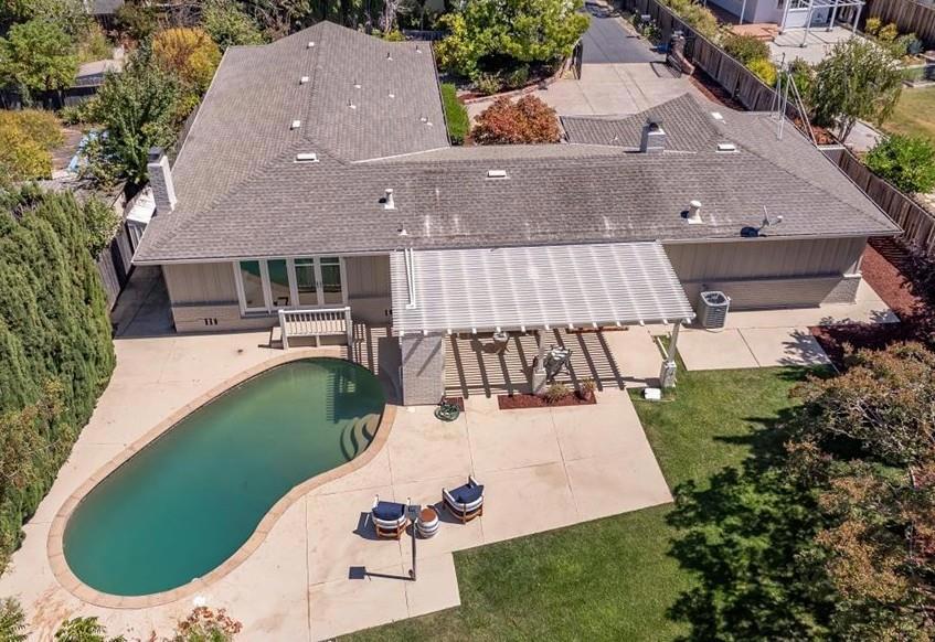 A rare find in a great Redwood City location! This 4 bedroom, 3 bathroom gated home on a flag lot offers the utmost in privacy and seclusion. Step into the formal entry and you will be drawn to the spacious living room with beautiful stone hearth fireplace and glass doors leading out to the pool and patio. Note the beautifully refinished hardwood floors, crown molding and baseboards that are found throughout the home. The designer kitchen features stunning custom cabinets, new quartz countertops, stainless steel sink and faucet, and gorgeous tile floor. It flows to the dining/family room with brick fireplace and sliding doors that access the fabulous and private yard. The primary suite offers a wall of custom closet cabinetry and a sliding door to the peaceful front yard. The primary bathroom with dual sinks, oversized stall shower, tub with jets and walk-in closet complete this retreat. Enjoy the huge yard with lawn, patio, pool, and beautiful mature landscaping, front and back. Other features include: recessed lighting, updated windows & exterior doors, newly painted interior and exterior, fruit trees, and a well. Centrally located and close to everything- shopping, parks, commute routes, and bustling downtown Redwood City with great restaurants and entertainment.
