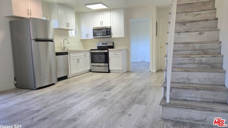 Two-story townhouse style. 3 beds & 2.5 baths. The unit has undergone extensive upgrades in recent years. The vinyl/laminate floor is throughout the unit.  Quartz kitchen and vanity countertops. The windows and balcony doors are double-paned. All bedrooms and the living room have balconies offering a mountain view with the Hollywood Sign. Two separate parking spaces. Walking distance to the Metro station. Good FW access. Close to the groceries. Quiet street.