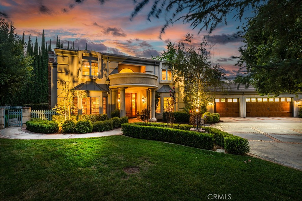 Chasing luxury, privacy, and a golfer’s paradise? Here is your ace! Within a friendly, well-maintained neighborhood, this South Redlands modern neo-classical estate is as close as you can live to the exclusive Redlands Country Club. Through the security gate, enter a spacious circular driveway surrounded by a beautifully & meticulously landscaped lawn and rose garden. A grand pillared portico lends an elevated air to this prestigious estate! Inside, you are greeted by a formal entry with intricate parquet wood floors and a gorgeous staircase with turned railings. Lounge at the end of your day in the family room or living room, by the warmth of two fireplaces. Or come outside and unwind on the roomy, covered brick patio with a view of the manicured gardens. Jump into a tiled pool in the summer or soak in your private spa all year-round. Your backyard oasis is surrounded by a tall, lush privacy hedge and stately cypress trees. From here, follow your own private walkway that leads you right out onto the seventh tee. For the home cook and host, your gourmet kitchen sports plenty of granite countertops and an island. Here, find a slew of upgraded appliances, including a Sub-Zero fridge, Thermador gas cooktop, and a double oven and dishwasher by Whirlpool. Host dinners in your formal dining room or have a quick meal in the sunlit breakfast nook. All bedrooms but one feature walk-in closets. Your second-story primary suite is spacious with an additional sitting/dressing area. From your primary bedroom, you’ll enjoy immediate deck access, so you can take in the early morning sunshine to start your day! In your ensuite bathroom, enjoy the convenience of a separate walk-in shower and soaking tub. Bathrooms have been upgraded with granite and tile. Back downstairs, work from home or curate your personal library in a mature study with custom-built-in hardwood shelves and tons of room. A large inside laundry room has a utility sink and an ironing/sewing space. Includes an attached three-car garage, plus a single garage space that can be converted into a space for your golf cart. The estate is protected by a home security system. Solar panels power the home and pool. Part of the highly-rated Redlands Unified School District. Schedule your private showing today!