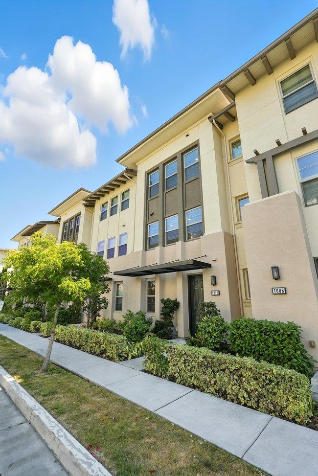 Welcome to 1012 Foxglove Place, a quiet three-story home designed for comfort and style. The top floor features two spacious en-suite bedrooms, offering privacy and convenience for modern living. On the ground level, a versatile den with closet and half bath is perfect for a home office, gym, or guest space. The second floor is the heart of the home, showcasing an open kitchen, dining, and living area filled with natural light. Recent upgrades include brand-new hardwood flooring, fresh designer paint, LED lightings, HVAC system, tankless water heater, water filtration system, triple-pane windows, and cordless blinds in every window. A rare side-by-side two-car garage adds everyday ease and extra storage. Located in the desirable Orchard Park community, enjoy a low HOA fee, excellent amenities, and close proximity to BART, tech hubs, highways, shopping, and dining. Move in Ready!!