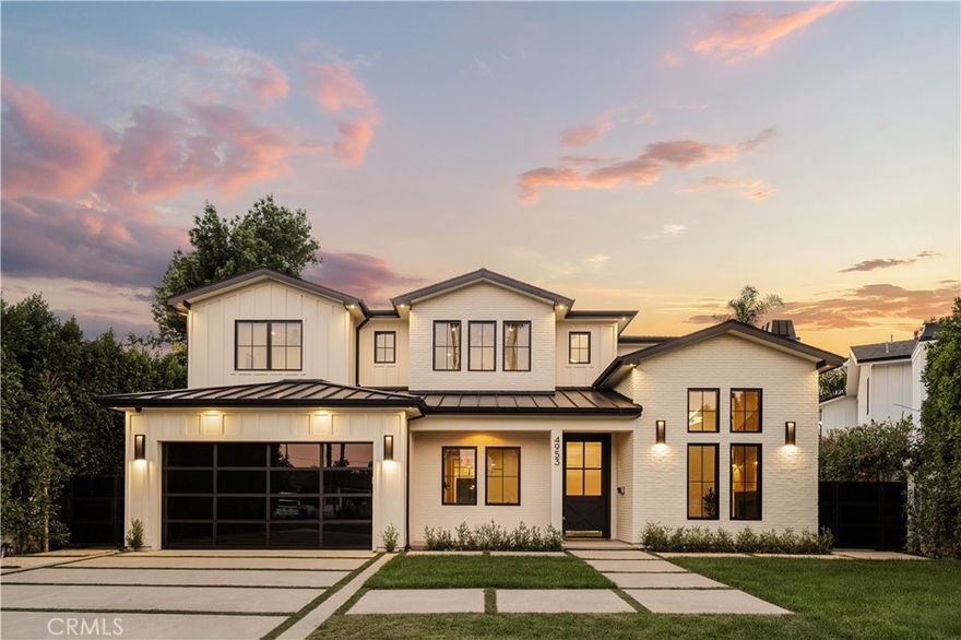 Tucked away on a peaceful cul-de-sac, this stunning Contemporary Farmhouse offers 5 bedrooms, 5.5 bathrooms, and over 4,500 square feet of luxurious living space, showcasing timeless design and exceptional craftsmanship throughout. The grand entry opens to a bright, open layout featuring a formal dining room adorned with custom wood detailing and a bar/butler’s area with a walk-in pantry. Across the hall, the formal living room impresses with vaulted ceilings, abundant natural light, and a striking fireplace framed in white oak paneling that extends to the ceiling. Beyond the elegant staircase, the open-concept family room and chef’s kitchen blend seamlessly with the backyard through expansive pocket doors, creating the perfect indoor-outdoor flow for year-round entertaining. The family room features built-in cabinetry, white oak accents, a stone fireplace, and a 75-inch TV for relaxed living. The adjoining gourmet kitchen is a showpiece with Thermador appliances, custom cabinetry, intricate tile work, a breakfast nook, and a large eat-in island. The lower level also includes a theater and an en-suite guest bedroom currently used as a gym. Upstairs, the primary suite serves as a serene retreat with vaulted ceilings, a marble fireplace, dual walk-in closets, and a spa-like bathroom featuring marble tile, dual vanities, a soaking tub, and an oversized rain shower with a built-in bench. Three additional en-suite bedrooms and a laundry room complete the upper level. The private backyard is an entertainer’s paradise, boasting lush landscaping, a pool and spa, BBQ area, fire pit, and grassy play space. Ideally located within the Hesby Oaks School District and minutes from the 101/405 freeways and vibrant Ventura Blvd, this home captures the essence of modern California living.