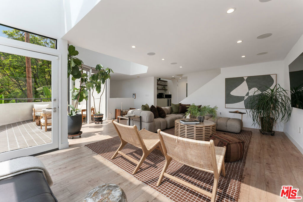 BEST OPPORTUNITY IN THE HOLLYWOOD HILLS!!!! Elevated above the city in the Hollywood Hills this striking modern retreat defines the pinnacle of California living. Floor-to-ceiling glass captures sweepingcityscapes and canyon vistas, while seamless indooroutdoor flow leads to sun-soaked patios, a sparkling pool, and intimate spaces for dining beneath the stars. The chef'skitchen is a true centerpiece, boasting a 6-burner Viking range, custom Dacor built-in refrigerator, new cabinetry, and generous counter space, designed to inspire bothculinary creativity and effortless entertaining. On the second level, an expansive living room opens to multiple terraces, each offering breathtaking views and creating anideal setting for gatherings large or small. A versatile office doubles as a media room, providing both functionality and style for modern living. Upstairs, the primary suite is aserene sanctuary, anchored by a fireplace and framed by gracefully curved windows that showcase the glittering downtown skyline. The spa-inspired ensuite features dualsinks, a rain shower, and a spacious walk-in closet, perfectly blending luxury with comfort. Two additional bedrooms are bright and generously proportioned, including onewith direct access to the sun-drenched, solar-heated pool. Every detail has been meticulously considered: smart lighting and shades, Multiple zoned SONOS home audio, CAT 5 Wiring, 240v EV charging, and refined finishes throughout. This home is for the discerning buyer who seeks sophistication, privacy, and effortless access to LosAngeles' finest dining, shopping, and cultural experiences. Fireplaces are strictly decorative.