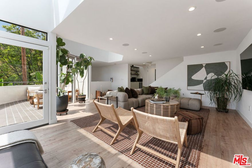 BEST OPPORTUNITY IN THE HOLLYWOOD HILLS!!!! Elevated above the city in the Hollywood Hills this striking modern retreat defines the pinnacle of California living. Floor-to-ceiling glass captures sweepingcityscapes and canyon vistas, while seamless indooroutdoor flow leads to sun-soaked patios, a sparkling pool, and intimate spaces for dining beneath the stars. The chef'skitchen is a true centerpiece, boasting a 6-burner Viking range, custom Dacor built-in refrigerator, new cabinetry, and generous counter space, designed to inspire bothculinary creativity and effortless entertaining. On the second level, an expansive living room opens to multiple terraces, each offering breathtaking views and creating anideal setting for gatherings large or small. A versatile office doubles as a media room, providing both functionality and style for modern living. Upstairs, the primary suite is aserene sanctuary, anchored by a fireplace and framed by gracefully curved windows that showcase the glittering downtown skyline. The spa-inspired ensuite features dualsinks, a rain shower, and a spacious walk-in closet, perfectly blending luxury with comfort. Two additional bedrooms are bright and generously proportioned, including onewith direct access to the sun-drenched, solar-heated pool. Every detail has been meticulously considered: smart lighting and shades, Multiple zoned SONOS home audio, CAT 5 Wiring, 240v EV charging, and refined finishes throughout. This home is for the discerning buyer who seeks sophistication, privacy, and effortless access to LosAngeles' finest dining, shopping, and cultural experiences. Fireplaces are strictly decorative.