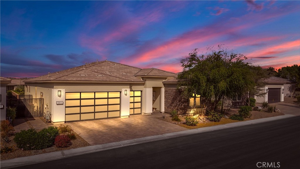 Your desert retreat in the impeccable Trilogy at The Polo Club - 55 or better section. This 3 bedroom, 4 bath home with a bonus room/ office was designed with every upgrade imaginable, and showcases an open floor plan that includes seamless indoor/ outdoor flow for both entertaining and resort-style living. The immaculate kitchen features a jumbo island with breakfast bar, luxury stainless steel appliances, and contemporary finishes. The dining area, situated just off the kitchen, has a stunning view through the large-format three-panel sliding glass door perfect for catching those spectacular sunsets the valley is known for. All of this is open to the great room, where a custom built-in TV and fireplace accent wall create the perfect space for catching up with friends, watching TV, or reading a book. Outside, your private oasis awaits: the sparkling pool and spa, fire table, and covered patio make for easy enjoyment year-round. Consider with that the large surrounding hedges, no neighbor behind you, and a premium key lot location, and you’ll enjoy peace, privacy, and wide-open views of the Santa Rosa mountains. Additional features include a finished two-car garage plus a golf cart garage, laundry room, upgraded flooring, and thoughtful touches that make this home comfortable and luxurious. Conveniently located close to the gate for easy access, this property also offers a transferable membership to the acclaimed Trilogy Polo Club lifestyle, with resort-style amenities, social events, and community connections just waiting for you.