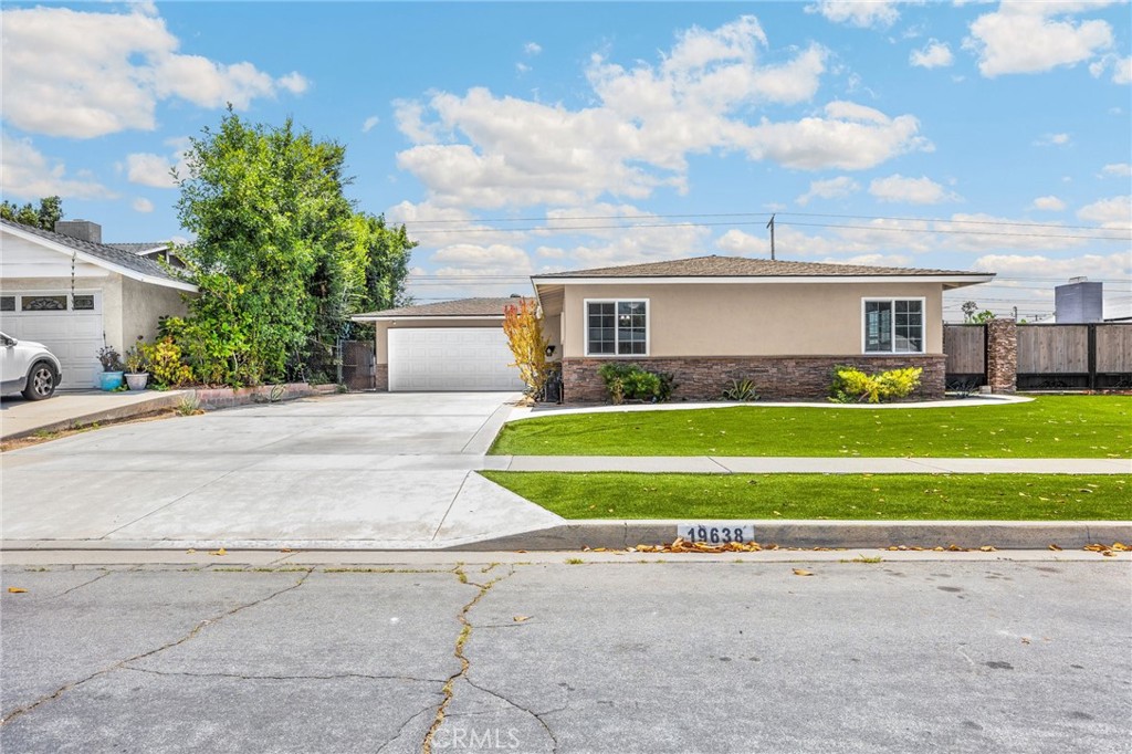 This beautifully upgraded home is located in the highly desirable Charter Oak Unified School District and features a remodeled kitchen with grey quartz countertops, white cabinetry, and a classic white tile backsplash, complemented by a White GE refrigerator and stainless steel oven and microwave. The kitchen flows into a spacious dining and living area, creating an open layout that leads to an even larger backyard with a covered patio—perfect for relaxing or entertaining. Both bathrooms have been tastefully remodeled, and the home includes recessed lighting, dual-pane windows, new interior and exterior paint, and laminate flooring throughout. Additional upgrades include a newer heating and air system, security camera system, and sprinkler system. The exterior offers a new concrete driveway, newer rear fencing, updated stucco, stacked stone hardscape, and artificial grass for great curb appeal. The property also features RV parking with stacked stone pillars and a decorative welded gate, plus a two-car attached garage and oversized driveway.