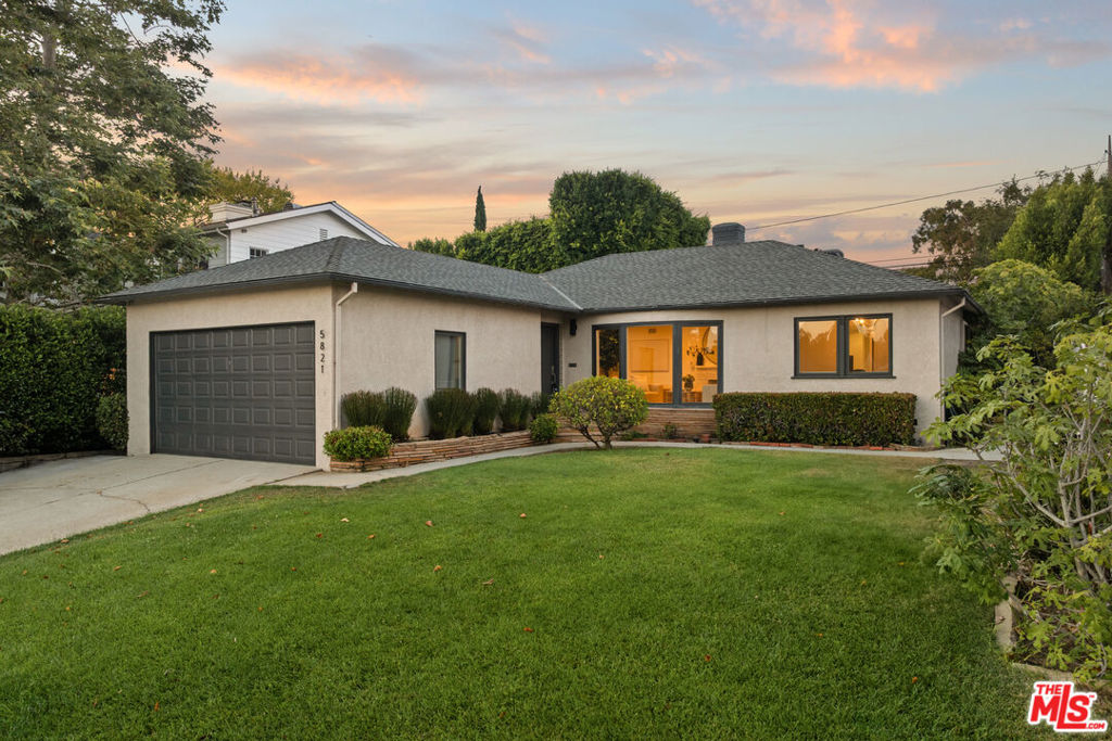 Set on an expansive 7,793 sqft lot adorned with stately palm trees, this beautifully updated single-level residence blends comfort, style, and thoughtful design. A spacious attached two-car garage and wide frontage create an impressive presence from the street, while inside, picture windows in the living room frame peaceful views of the lush front yard. A gas fireplace and adjacent dining area provide a warm and inviting space for gatherings. The remodeled eat-in kitchen, complete with a charming breakfast nook, opens to a private backyard oasis. Here, an outdoor fireplace, generous patio, mature trees, and a large grassy lawn offer the perfect backdrop for alfresco dining, play, and relaxation. Gorgeous hardwood floors and custom tile span the home, enhancing its timeless appeal. The primary suite is quietly situated at the rear of the home, adjacent to a flexible fourth bedroom ideal for a nursery, home office, or guest space. This is the rare blend of single-level living, outdoor charm, and interior sophistication you've been waiting for.