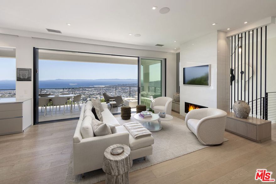 Perched atop Santa Barbara's Riviera, this newly built, one-of-a-kind contemporary masterpiece offers unparalleled elegance, cutting-edge technology, and seamless indoor-outdoor living. Constructed by Allen Construction and enhanced by Cornerstone Landscapers, this exceptional residence showcases breathtaking panoramic ocean, city, and island views from every level. Expansive floor-to-ceiling sliding doors seamlessly fold, opening the home to sweeping vistas from the outdoor terrace. The interiors boast soaring 10-foot ceilings, wide-plank wood floors, automated shades, Lutron lighting, and a state-of-the-art Savant smart home system. The gourmet Italian kitchen is a chef's dream, featuring sleek cabinetry, Wolf and Miele appliances, Sub-Zero refrigeration, and a butler's pantry with ample storage. The primary suite is a private sanctuary, offering blackout shades and a serene ocean-view terrace. The spa-inspired marble bath is designed for ultimate relaxation, complete with radiant heated floors, a soaking tub with breathtaking views, and a heated towel rack. Designed for resort-style living, the 15' x 45' infinity-edge pool and spa are complemented by an outdoor kitchen, automated sunshades, and lush landscaping. Additional highlights include a media room with a bar, a home gym with an infrared sauna, a security system, solar panels with LG Powerwall backup, and extensive drainage and irrigation systems. A true Riviera masterpiece, blending luxury, innovation, and sustainabilityjust minutes from downtown Santa Barbara.