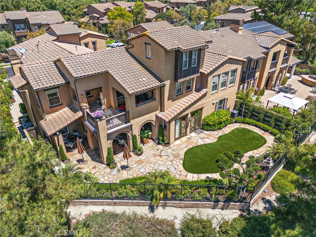 Perfectly positioned on a quiet cul-de-sac in the coveted gated community of Covenant Hills, this 3 bedroom, 2 bath home spans approx. 2,200 sq ft and offers the rare ease of true single-level living with no stairs. Designed for both comfort and entertaining, the residence features higher ceilings, wood floors, custom lighting, and an expansive great room that seamlessly blends the kitchen, dining, and living areas. The chef’s kitchen showcases a massive center island, rich cabinetry, beverage cooler, and abundant storage with direct access to the epoxy-finished 2 car garage. The dining area with built-in buffet and wine fridge flows naturally to the inviting living room, highlighted by a raised-hearth fireplace, media niche, and windows framing sweeping views. French doors in the oversized primary suite open directly to the backyard oasis, where a covered loggia sets the stage for year-round outdoor living. The reimagined yard boasts synthetic turf, updated hardscape, and wide open panoramic sunset views—all while providing exceptional privacy. The primary bath features a dual vanity, soaking tub, separate shower, and a large walk-in closet. Two secondary bedrooms—one with a walk-in closet, the other with built-in shelving—share a full bath in a separate wing with indoor laundry. Residents of Castillena enjoy 24-hour guard-gated security, award-winning schools, high-speed internet, and access to a wealth of amenities: multiple pools, tennis & pickleball courts, parks, trails, water park and even a skate park. This is the perfect blend of single-level ease, private outdoor living, and resort-style community amenities—a true Tuscan-inspired retreat.