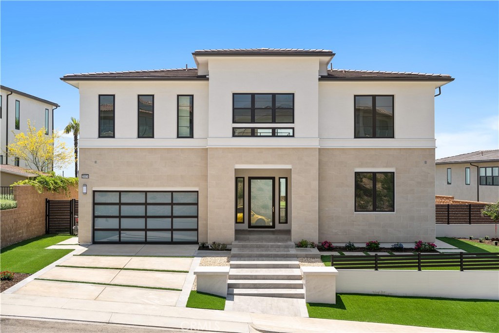 Located in the prestigious guard-gated community of Westcliffe at Porter Ranch, 20414 Marlow Lane offers elevated living with modern design and sweeping views. Inside, a dramatic open-concept layout showcases soaring ceilings, wide-plank hardwood floors, and expansive windows that frame the cinematic backdrop of sky and mountains. A sleek linear fireplace anchors the main living area, enhancing both warmth and optical appeal.
The chef's kitchen is a study in modern elegance, featuring an all-white aesthetic, brand-new stainless steel appliances, a marbled waterfall island and backsplash. A walk-in pantry provides practical storage. Upstairs, a large den overlooks the stunning surroundings—ideal as a media room, lounge, or office.
The primary suite is a luxurious retreat with a spa-inspired bathroom that includes dual vanities, a soaking tub, oversized glass-enclosed shower, and striking marbled finishes with bold black hardware. An expansive walk-in closet adds to the home's highly sought-after amenities.
Step outside to a beautifully designed backyard—an artful mix of marble accents, lush greenery, decorative tilework, and smooth pebble hardscape. An outdoor fireplace and putting green make this space as functional as it is visually stunning! The endless sky views and tranquil landscaping make this setting unforgettable.
Equipped with solar panels and located moments from Whole Foods, top-rated schools, shopping centers, and dining options, this home offers both luxury and convenience in one of Porter Ranch's most desirable enclaves.