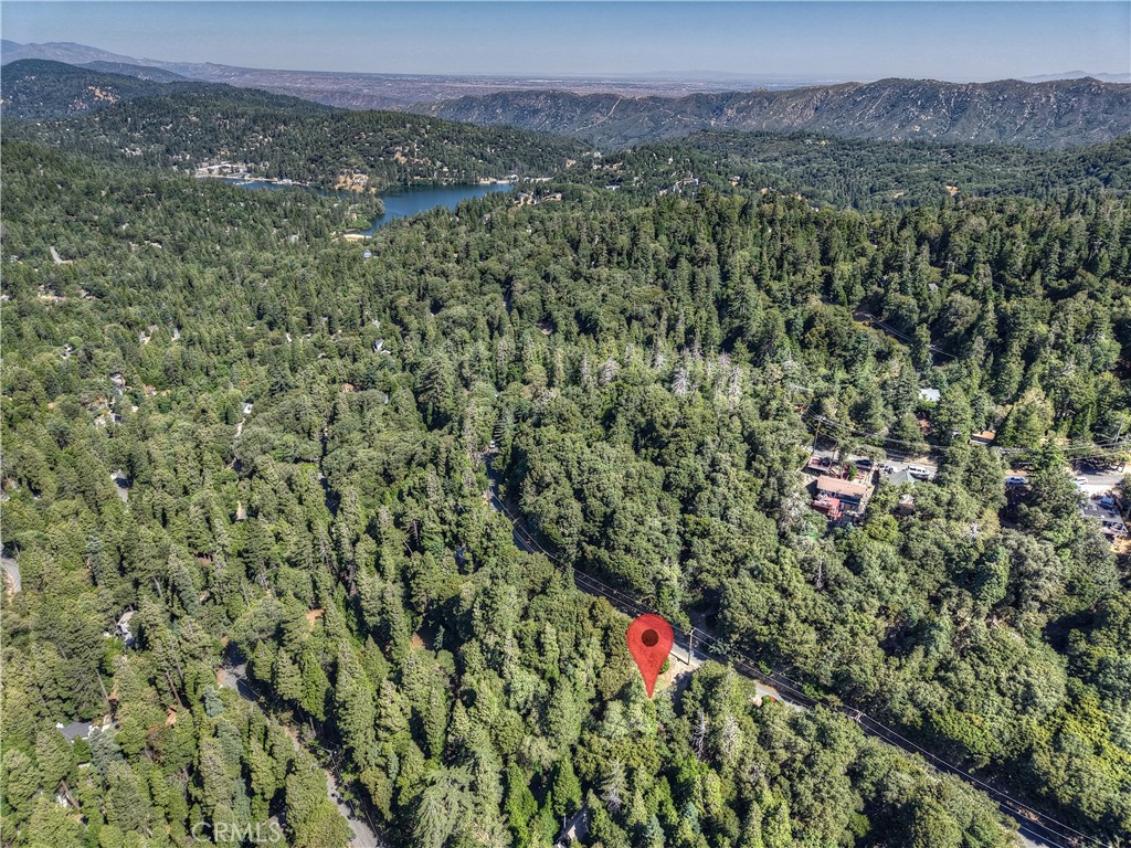 Build your mountain getaway in Crestline, California ~ This is a 5,000 square foot lot ~ Located just minutes from Lake Gregory, hiking trails, and loads of outdoor recreation ~ Take in the fresh mountain air, year-round beauty, and experience a true sense of retreat ~ Bring your vision to life - your canvas in this San Bernardino mountain community awaits! No address has been assigned to this property.