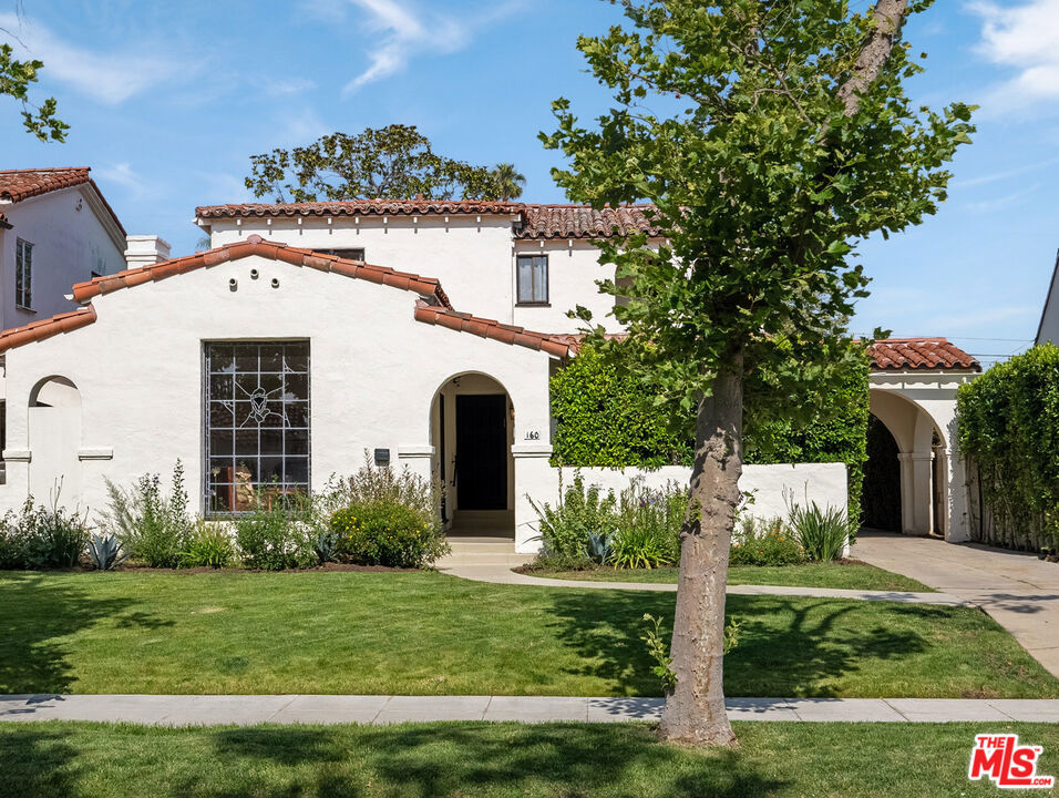 First access Thursday Sept 25th. Timeless Spanish Colonial Revival with Authentic Character, Pool, and Prime Location. Step into a bygone era of Los Angeles architecture at 160 S Poinsettia Place, an unspoiled 1930s Spanish Colonial Revival residence nestled in the heart of Miracle Mile's Historic Preservation Overlay Zone. This soulful 4-bedroom, 3-bath home embraces original character with lovingly preserved vintage details, offering the rare opportunity to move in and enjoy now or thoughtfully improve over time. Beyond the arched front gate, a sun-drenched private courtyard leads you to an entry adorned with hand-painted tiles. Inside, classic elements shine: a step-down living room with beamed ceilings, a cozy decorative fireplace, and a gorgeous historic stained glass west facing window. Gleaming hardwood floors throughout. The formal dining room is ideal for gatherings, while the current and remodeled kitchen with an open breakfast room, has been updated with stainless appliances, a built-in wine fridge, generous pantry, and an adjacent full laundry room. Upstairs, three bedrooms bask in natural light from south, west, and eastern exposures. Two original tiled bathrooms remain virtually untouched offering charm and authenticity that discerning vintage home enthusiasts will cherish. The downstairs features a guest bedroom, an additional home office with no closet but potentially yet another bedroom, and third bath perfect for flexible living arrangements. Out back, discover a resort-like setting with a sprawling 7,957 sq ft lot, lush landscaping, and a striking, Hollywood-scale pool framed in Spanish tile and crowned with a waterfall. Entertain year-round beneath the covered patio with its original built-in outdoor fireplace and grill. The detached garage and adjacent changing cabanas add to the home's period allure, with long gated driveway parking for up to seven vehicles. Additional features include upgraded central HVAC with Nest control, and potential for ADU development (buyer to verify). New roof curated using the original tiles where available. All just moments from The Grove, Erewhon, El Coyote restaurant, Pan Pacific Park, and LA's culinary and design corridor on Beverly Blvd. A rare find for those who dream of old-world charm, layered history, and the elegance of true Spanish architecture. No public open houses. Please feel free to make an appointment to preview. No sign on property.