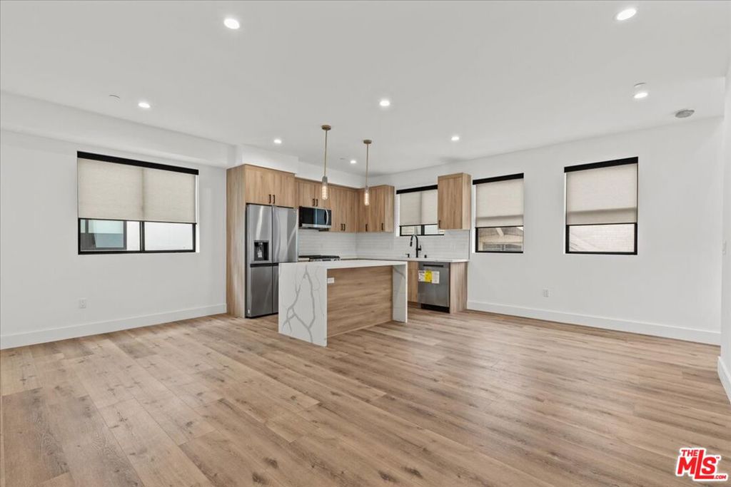 Welcome to this stunning brand new 3-bedroom, 3.5-bathroom townhome located just minutes from USC. This townhome is perfect for students or professionals seeking modern comfort and convenience. Enjoy spacious living with a large open-concept living room that seamlessly flows into a sleek kitchen, featuring a generous island perfect for dining, quartz countertops, and stainless steel appliances. Each bedroom includes its own private en-suite bathroom for added privacy and comfort. A versatile bonus room offers the ideal study space, home office, or media room to suit your needs. Step outside to your private rooftop deck with views of Banc of California, DTLA and the Coliseum. The rooftop deck is the perfect spot for relaxing, entertaining, or enjoying sunset views,. Additional highlights include an attached 2-car garage, in-unit laundry, and a gated property for extra security. Located in a vibrant, student-friendly neighborhood with easy access to campus, dining, and public transit. Don't miss your chance to live in style near USC!