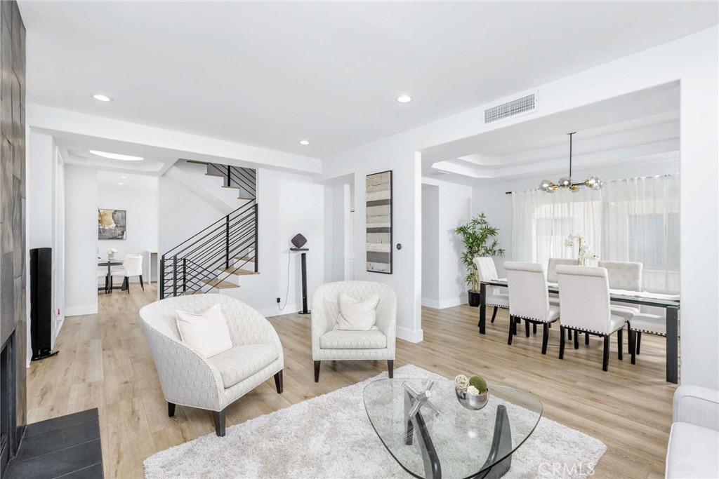 Welcome to your private sanctuary in the heart of Tarzana—an elegant, tri-level 3-bedroom, 3.5-bath condo offering over 2,100 square feet of thoughtfully designed living space. This light-filled home blends modern finishes with a warm, inviting feel, featuring wide-plank flooring, recessed lighting, and a stunning open-concept layout perfect for both relaxing and entertaining. The chef-inspired kitchen is a true showpiece, boasting European cabinetry, a marble waterfall island, and sleek fixtures that elevate everyday living. Each bedroom offers its own en suite bathroom, creating three separate retreats with spa-like finishes. The luxurious primary suite includes a marble fireplace, private balcony, walk-in closet, and a serene bath with double vanities, a soaking tub, glass-enclosed shower, and heated toilet. A dramatic formal dining area flows into the living room with a striking fireplace and French windows, while the expansive rooftop deck invites peaceful mornings or evenings under the stars. Additional features include a private two-car garage with epoxy flooring, modern steel railings, and thoughtful storage throughout—all within a well-maintained community close to the 101, Providence Cedars-Sinai Medical Center, local parks, hiking trails, and vibrant shopping and dining.