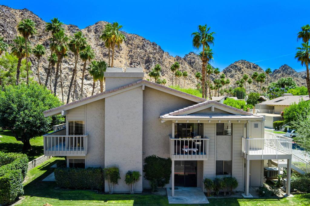 Beautiful, gated Mountain Cove is one of the secret hidden jewels of Indian Wells. Directly adjacent to the legendary Indian Wells CC, and nestled right next to the dramatic Santa Rosa mountains, it offers an absolutely perfect location to its residents. This is perhaps the nicest condo in the entire community. Freshly renovated with high-end designer touches throughout such as Versace wallpaper, custom tile-work, and furnishings from Anthropologie and Crate & Barrel. Spacious and well laid-out, this second floor unit features a gorgeous vaulted wood-plank beamed ceiling, gleaming stainless kitchen, and TWO large bedrooms - each with their own private remodeled baths. Then, the entire condo is surrounded by cozy outside patio decks. Large great room with soaring ceiling and gas fireplace is totally open to the dining area and kitchen. Efficient kitchen offers newer appliances, custom cabinetry, and a beautiful quartz waterfall countertop. Convenient inside laundry room with full-sized washer and dryer is conveniently located right off the kitchen. Both bedrooms are well separated ensuring maximum privacy and comfort. Entire condo was completely remodeled recently and is being offered TURN-KEY FURNISHED, allowing its new owners to move right in - OR for immediate use as a luxury rental. Nice corner, end-unit with its own 1-car garage, plus parking space. Indian Wells offers its residents unparalleled amenities such as steeply discounted golfing at two championship courses, discounts at all IW resorts and spas, free use of the Grand Hyatt fitness center, and much more. Condo is within easy walking distance to the world-famous Indian Wells Tennis Garden, home of the ''5th Slam'' BNP Paribas tennis tournament. Von's, Trader Joe's, Stater Bros grocers are a 5-minute drive away as are many restaurants, services, medical. Only 10 minutes to famed El Paseo shopping district with its upscale restaurants, galleries, shopping and amenities, College of the Desert, and McCallum Theater. Golf cart ride to several top golfing venues.