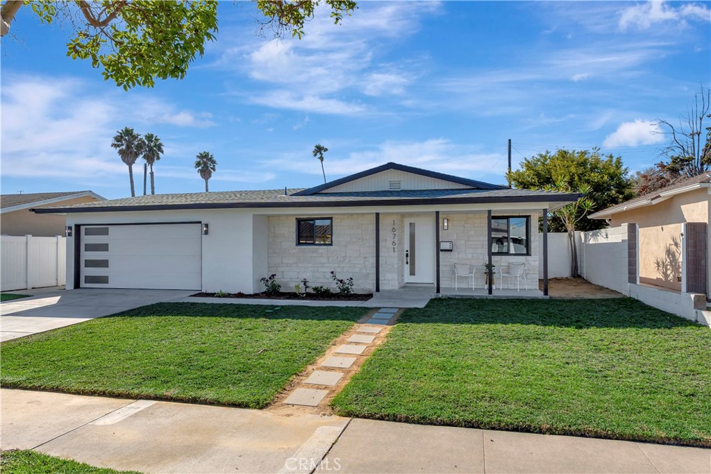 Stunning single-level coastal modern home that has been completely reimagined with timeless style and high-end finishes throughout with a fabulous, quiet interior tract location. This beautifully remodeled 3-bedroom, 2-bath residence offers an effortless blend of warmth, sophistication, and functionality. Step inside to discover a bright, open-concept floor plan filled with natural light and sleek designer details. The spacious living area centers around a striking modern fireplace, creating an inviting focal point perfect for both relaxing and entertaining. The chef-inspired kitchen features warm natural wood cabinetry, stylish countertops, stainless steel appliances, a large island with seating and a large dining area ideal for gatherings. Both bathrooms have been fully remodeled with modern gold fixtures, floating vanities, and elegant finishes, evoking a spa-like sense of luxury. Outside, enjoy a private backyard retreat-a perfect setting for outdoor dining or soaking in the coastal breeze. Attached 2 car garage with new epoxy floors and direct access in to the kitchen. Ideally located in a desirable Huntington Beach neighborhood near top-rated schools, parks, shopping, dining and the freeways -  this home perfectly captures the essence of modern living!