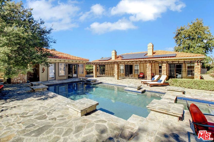 Beautifully furnished and perfectly situated at the end of a cul de sac, this highly desirable single-story home is located in the gated, prestigious Signature Collection community. With 4 bedrooms, 3.5 bathrooms and a large stand-alone guest house with bathroom, this house is perfect for a growing family or a couple who likes to host and entertain! As you enter the bright, beautiful foyer, you will enjoy a large formal living room with gorgeous wood burning fireplace and large double glass doors that provide an expansive view of the pool and backyard. There is a delightful formal dining area and a library/den, off the foyer, that doubles as the ideal home office location. Entertain your guests and family in the gourmet Viking kitchen with 48" counter top range, large center island with breakfast bar, and a breakfast nook that connects to the adjoining family room with a dramatic floor to ceiling stone fireplace. The spacious master suite showcases a third fireplace, luxurious spa bath and separate jacuzzi tub. The additional bedrooms are ensuite. The guest house has a spectacular floor-to-ceiling custom tile shower, wet bar and plasma TV and works as separate guest quarters, game room, office or home theater! This home is carefully curated with beautiful stone floors, custom built ins, designer window treatments, gorgeous rugs, custom tile and designer appliances. This home is replete with a large pool, spa, custom barbecue area, and private backyard that backs up to North Ranch open space that connects to Lang Ranch open space. Hike and bike for miles in stunning parkland! Located in award winning Conejo School District. Short term pricing available.