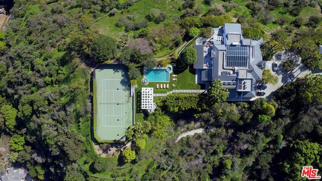 This trophy Bel Air Estate, on apx. 4 acres of sun bathed promontory, is located at the end of a long driveway. Enter through private gates into the circular motor court of this dramatic apx. 10K sqft 80's Architectural. There is a huge 2 story atrium with a spiral staircase that leads to a spacious master suite which encompasses almost the entire 2nd floor, with oversized double baths, closets, deck's and views galore. There are 5 bedrooms total and also a media room, game room and gym. The grounds include a tennis court, pool, pavilion, and covered parking for 8 cars. Breathtaking views in all directions - very private.
