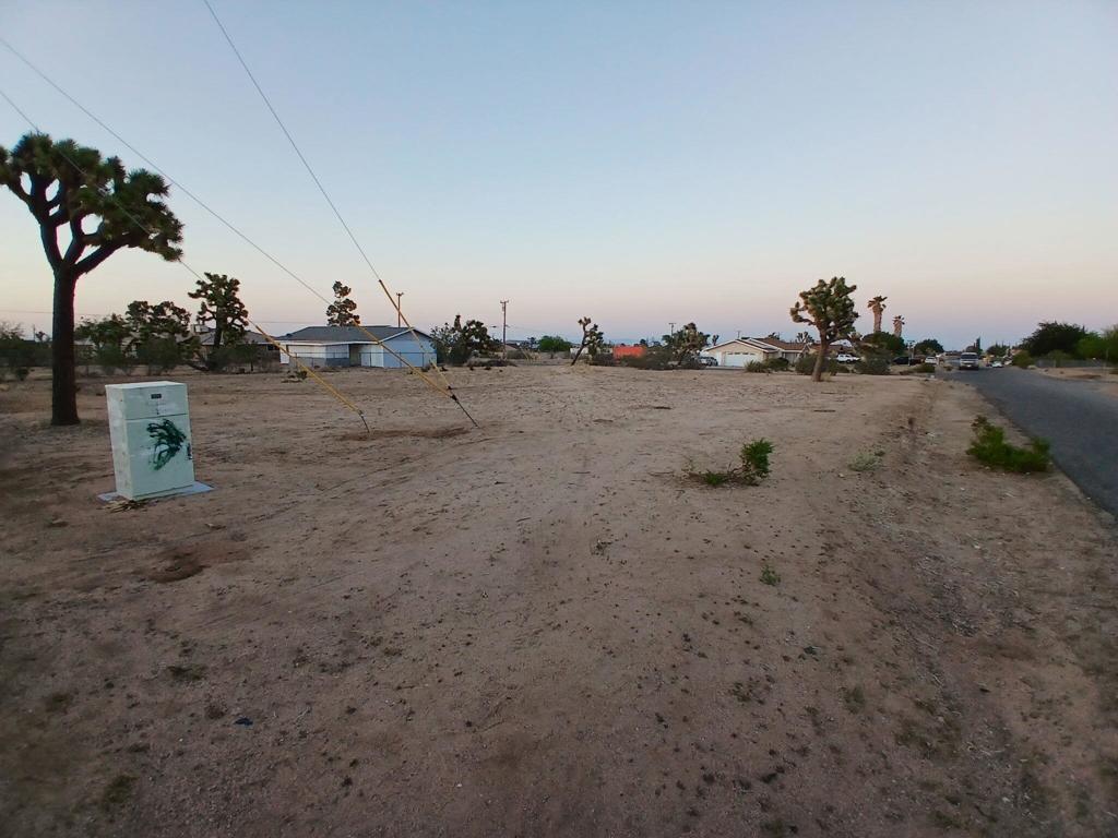 Great corner lot on a paved road in the Yucca Mesa area. Views and lovely homes surround it. Build your dream home in the peaceful tranquility of the high desert. The existing water meter has been paid for. Utilities are at the street. Please drive by and call with any questions.