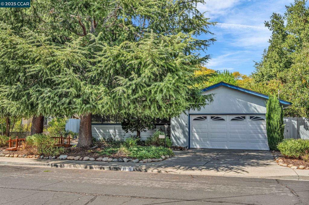 Sun-filled, charming single-story home located in a prime and convenient neighborhood just a short stroll from downtown Walnut Creek's amenities, the scenic Iron Horse Trail, and top rated schools! Gleaming hardwood flooring, rich tile and stone finishes, newer lighting fixtures, attached two car garage, and a large, level, private setting with a lush and backdrop of mature trees! The updated kitchen features maple cabinetry, slab granite counters, an impressive hammered copper hood, and convenient pantry. The bathrooms have been updated with solid surface counters, newer lighting, and gleaming glass tile. Newer paint, louvered doors, brick fireplace, and a wall of windows looking out to the lush garden setting. Amazing upside opportunity with an ample-sized back and side-yards offering plenty of room for future landscaping ideas, a possible home addition, pool, or ADU! Inviting curb appeal with meandering garden paths and majestic cedar trees leading to the porch entry. Flexible floorplan, perfect for entertaining with family and friends! A sunny and tranquil ambience permeates this prime starter home (or trade-down opportunity)! This unique and popular neighborhood offers vibrant energy and connectivity along with easy commuting access and proximity to downtown Walnut Creek!