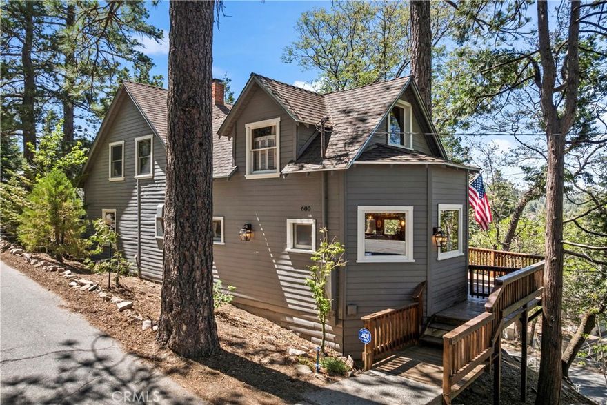 Restored Vintage Cabin Retreat – Twin Peaks Charmer Near Lake Arrowhead

Step into the magic of mountain living with this lovingly restored 5-bedroom, 1.5-bath vintage cabin nestled in a quiet corner of Twin Peaks, surrounded by other charming mountain homes. With room to comfortably sleep up to 10 guests, this home is ideal for creating lifelong memories in a peaceful, relaxed setting.

The heart of the home is a large, adorable living room featuring an old-school brick wood-burning fireplace—perfect for cozy evenings after a day of exploring the mountains. The kitchen is a true vintage delight, complete with a fully refurbished antique stove, classic cabinetry, and warm notty pine throughout. Rough-sawn Douglas fir details and rich wood finishes add to the authentic cabin character and rustic charm.

Bathed in natural light, the home enjoys a sunny location with distant views of the forest and desert. Recent upgrades include fully redone plumbing and electrical systems, a 40-year roof installed just a few years ago, and fresh exterior paint within the last year. Quality furnishings and tasteful décor are included in the sale, making this the ultimate turnkey mountain getaway.

Whether you’re looking to unplug, unwind, or host unforgettable weekends with friends and family, this rare gem offers the perfect blend of vintage soul and modern comfort. Come up, slow down, and enjoy the good life.