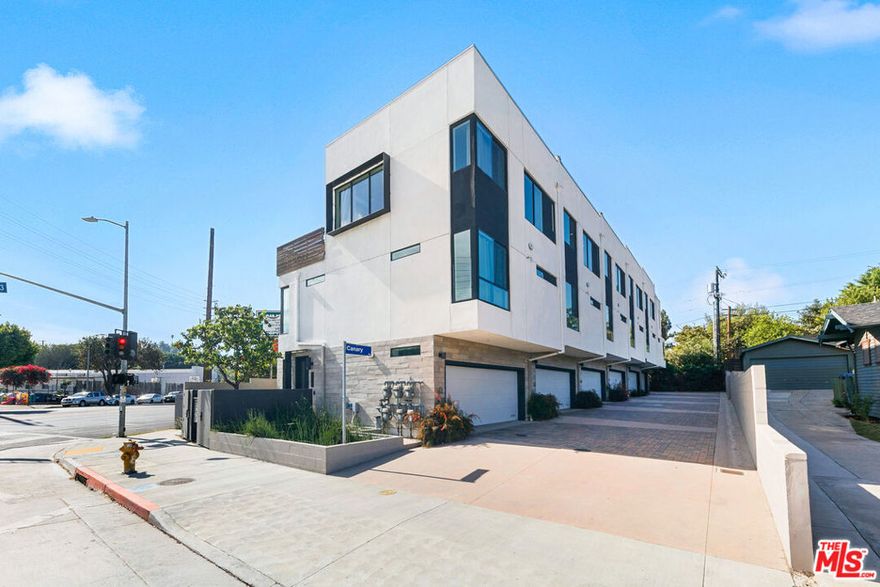 Welcome to modern Glassell Park living at its finest. Finished in 2020, this home sits elevated above the street, placing your main living space on the top floor where oversized windows capture natural light and frame beautiful San Rafael Hills views. The open floor plan seamlessly connects living, dining, and a sleek kitchen with breakfast bar and KitchenAid stainless steel appliancesperfect for entertaining or everyday life. Recessed lighting throughout enhances the contemporary aesthetic, while the flow from indoor to outdoor living leads you to your private rooftop deck with breathtaking 360-degree views. Imagine sunset gatherings, morning coffee rituals, or weekend brunches with the cityscape as your backdrop.The thoughtful layout provides 2 ensuite bedrooms on separate levels for ultimate privacy, each with their own full bath featuring oversized showers and modern finishes. The primary suite is a true retreat with a large walk-in closet complete with custom built-ins. A versatile bonus den off the entry adapts to your lifestylehome office, exercise room, creative studio, or guest space. The convenient half-bath on the main level keeps the flow effortless when hosting.Beyond the home's impressive features, the location delivers exceptional value. You're positioned in the heart of Glassell Park near Michelin-recognized Dunsmoor, beloved Bub & Grandma's bakery, The Grant's craft cocktails, and Verdugo Bar. The 2, 5, and 134 freeways provide quick connections to Downtown LA, Glendale, Burbank, Pasadena, Hollywood, and Eagle Rock. Add in a two-car attached garage, eco-friendly dual-pane windows, and low-maintenance hard surface flooring, and you have a turnkey newer construction home that checks every box in one of Northeast LA's most vibrant neighborhoods.