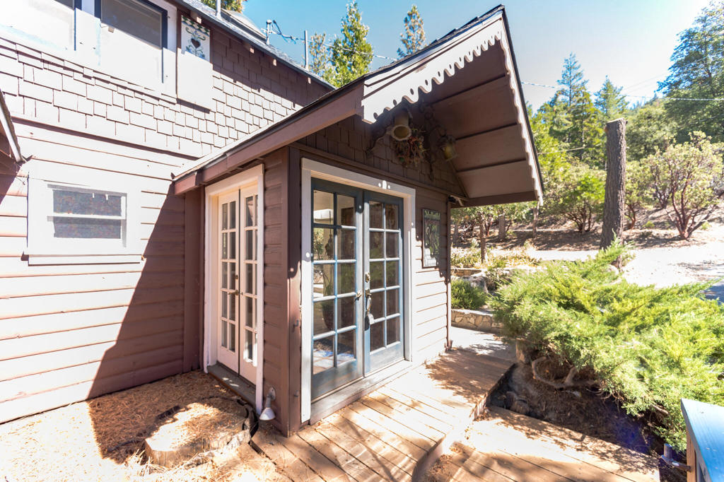 VIEWS OF Tahquitz Peak!! Main house with three bedrooms, two baths and a separate dining room is filled with CUSTOM woodwork. Beautiful back deck with amazing trees!! Studio lower level with kitchenette and 3/4 bath, own entrance with small deck. Guest house with full sized kitchen, one bedroom one bath. Property has 2 rv spots both with 50 amp hook ups! DON'T WAIT!!!! LIVE IN MAIN HOUSE AND RENT OUT OTHER TWO UNITS!!