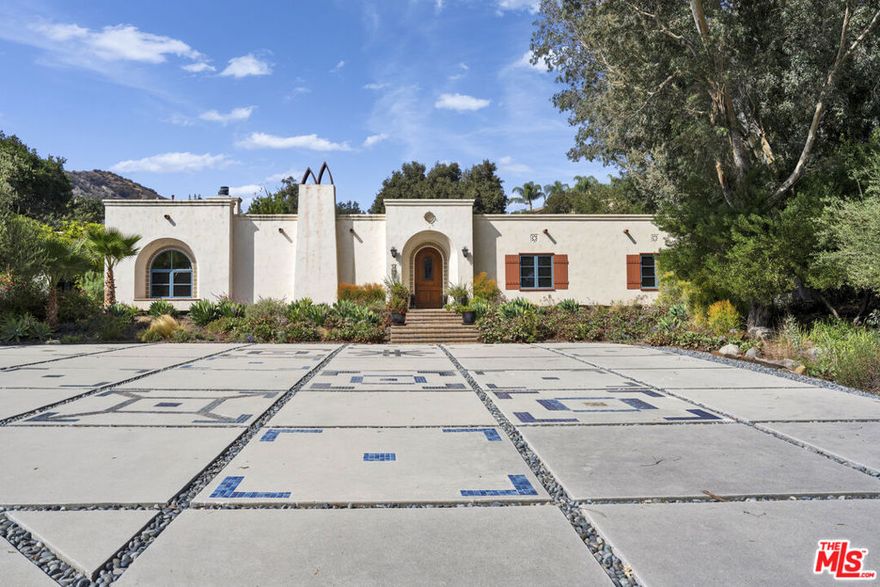 This exquisite Spanish Colonial home is a true showstopper. From the moment you arrive, the fully upgraded front yard beautifully hardscaped with elegant tilework and an automatic gate sets the tone for the sophistication inside. This home blends timeless charm with modern luxury. The chef's kitchen features custom cabinetry, a built-in Sub-Zero refrigerator, Viking range with double ovens, warming drawer, microwave, and farmhouse sink. A walk-in pantry with an automatic light and magnetic chalkboard door adds both style and function.Nearly every room opens to the lush backyard with pool, spa, orchard, and scenic hill views, creating the perfect setting for indoor-outdoor living and effortless entertaining.Additional highlights include a fully owned solar system no lease payments and numerous thoughtful upgrades throughout. Welcome home to your private oasis of beauty, comfort, and sustainability.