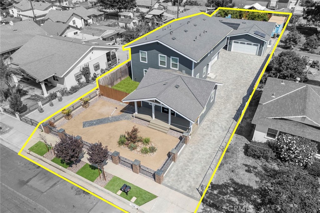 TWO ON A LOT AND BRAND NEW CONSTRUCTION! Welcome to a truly exceptional opportunity — two stunning, newly constructed custom homes thoughtfully designed on one oversized lot. Whether you’re searching for the ultimate family compound, a multi-generational living solution, or a unique income-producing property, this offering provides unmatched flexibility, luxury, and value. With each home separately metered and appointed with premium finishes, the possibilities are endless. From the moment you arrive, the inviting storybook covered porch sets the tone for the home’s perfect balance of character and contemporary living. Step inside through a dramatic double-door entry and into a light-filled great room, where wide plank LVP flooring, straight-edge baseboards, and a soft neutral color palette create an atmosphere of understated elegance. The chef’s kitchen combines beauty and function with crisp white shaker cabinetry, natural quartzite counters, stainless steel appliances (including double ovens), a farmhouse sink overlooking its own private yard, and a waterfall island with seating for four. Upstairs, retreat to a spacious primary suite featuring a custom-built walk-in closet and spa-inspired ensuite bath with dual vanities, an LED-backlit mirror, and an oversized walk-in shower. Three additional generously sized bedrooms, each with built-out closets and access to designer bathrooms, provide comfort and privacy for family or guests. Completing the home is a massive 750 sqft direct-access garage, offering ample room for vehicles, storage, or even a workshop. Tucked quietly at the rear of the property, the second single-story ranch home is designed with both convenience and style in mind. With approximately 1,200 sqft, this 3 bed, 2 bath home offers a welcoming open-concept floorplan, ideal for relaxed living. The kitchen mirrors the front home’s design with shaker cabinetry, quartzite counters, and stainless appliances, all flowing seamlessly into the dining and living spaces. Durable wood-look tile flooring, bright finishes, and thoughtfully placed windows enhance the sense of openness. Outside, a huge privately fenced yard with artificial turf and garden space provides the perfect setting for outdoor gatherings, play, or quiet relaxation. The oversized 525 sqft two-car garage offers generous parking and storage options. Opportunities like this with two beautifully designed homes rarely comes to market, this property is truly one of a kind.